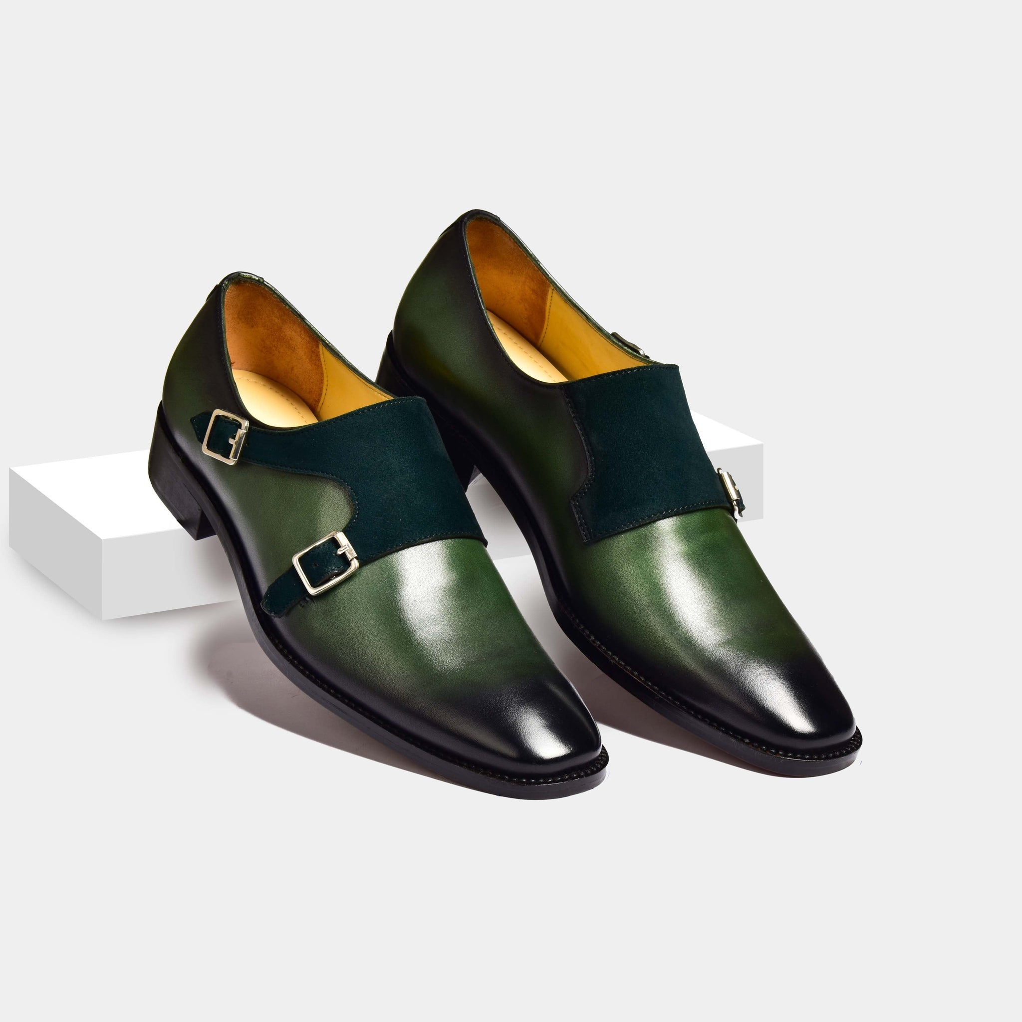 Pair of Chris Parker Leather Monk Straps in green leather with black double monk straps.