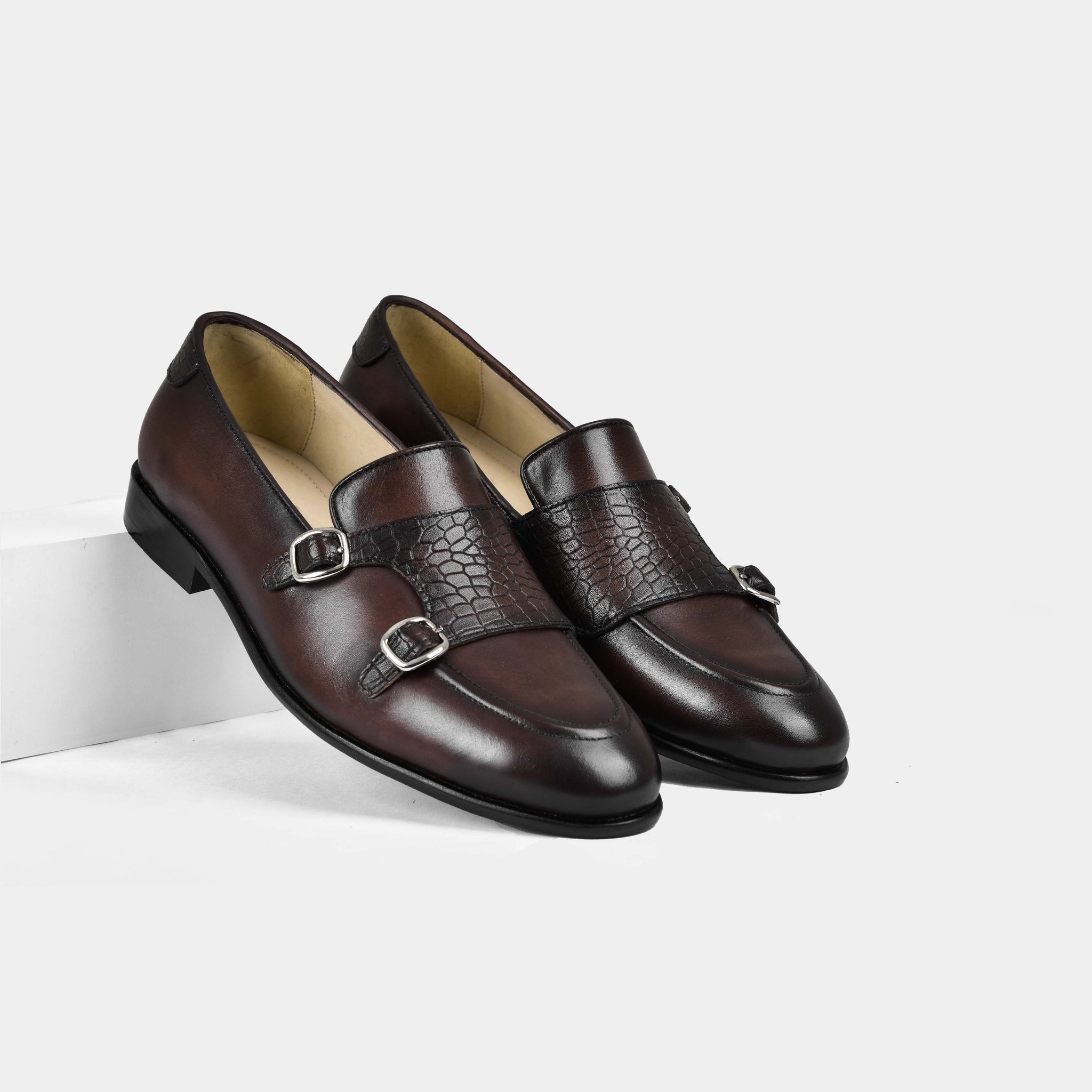 A pair of Armeo Brown Leather Monk Straps with crocodile-embossed straps and silver buckles.