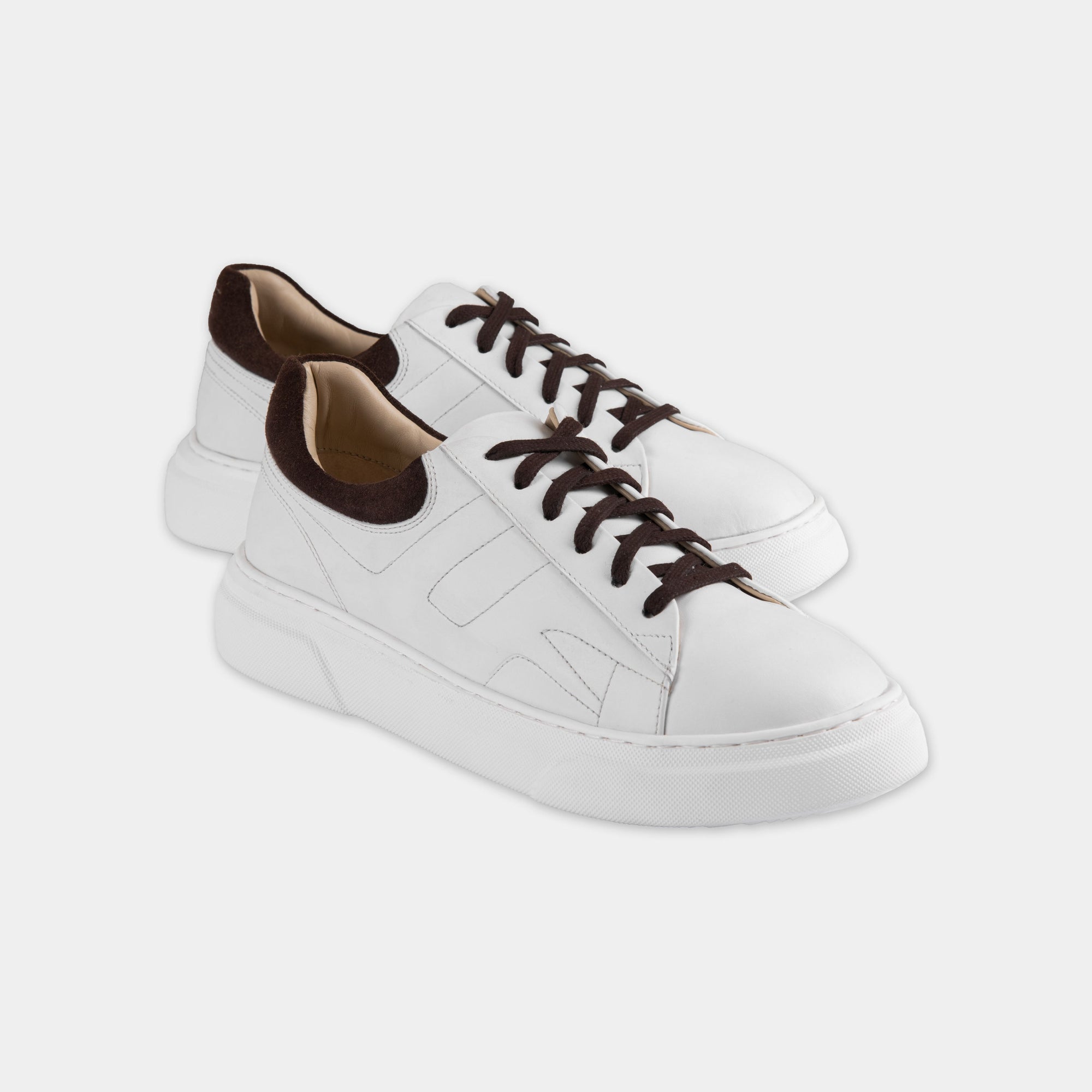 Pair of classic white lace-up sneakers for men with brown accents, ideal for casual and semi-formal looks.