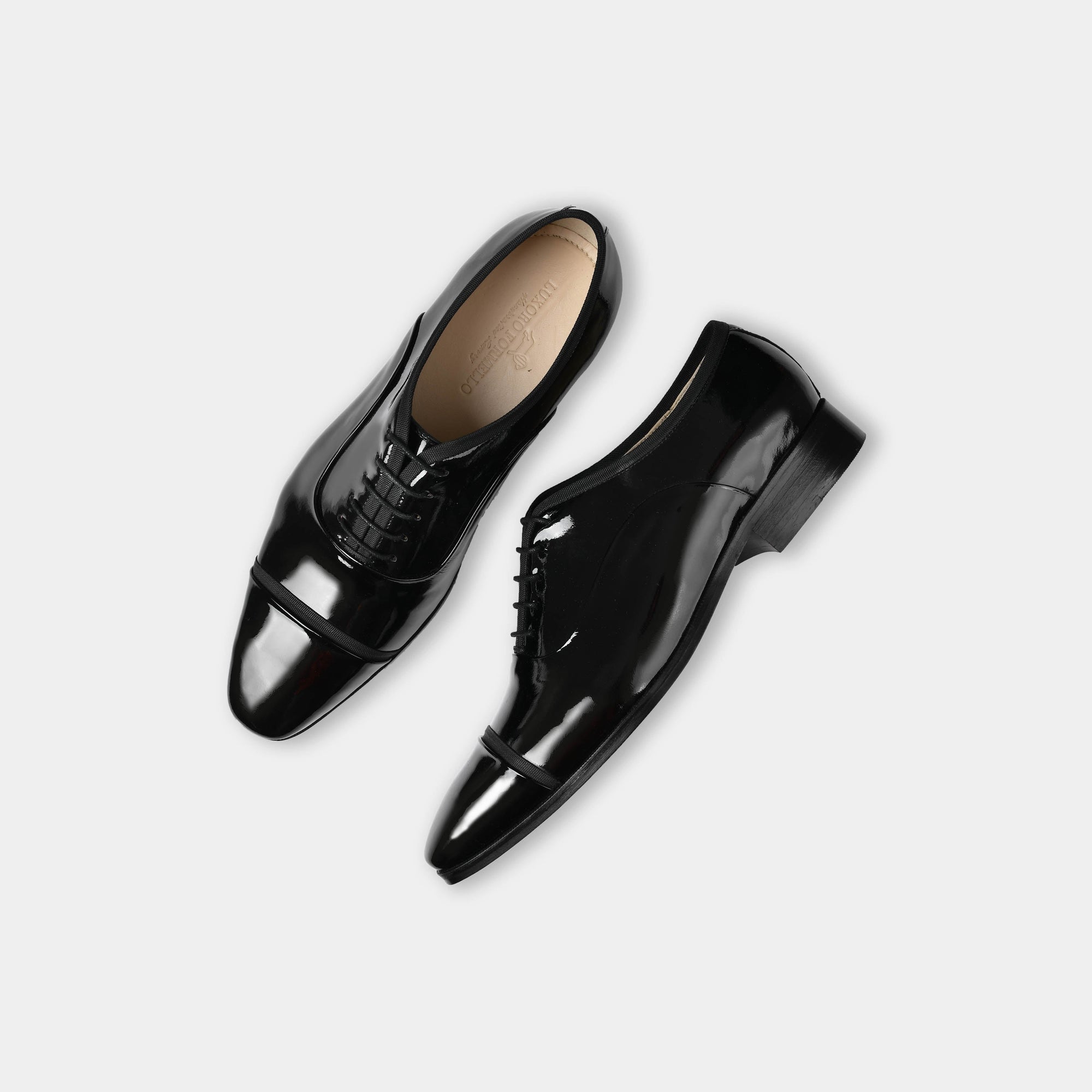 Pair of Lsandro Patent Leather Laceups in black, shown from above.