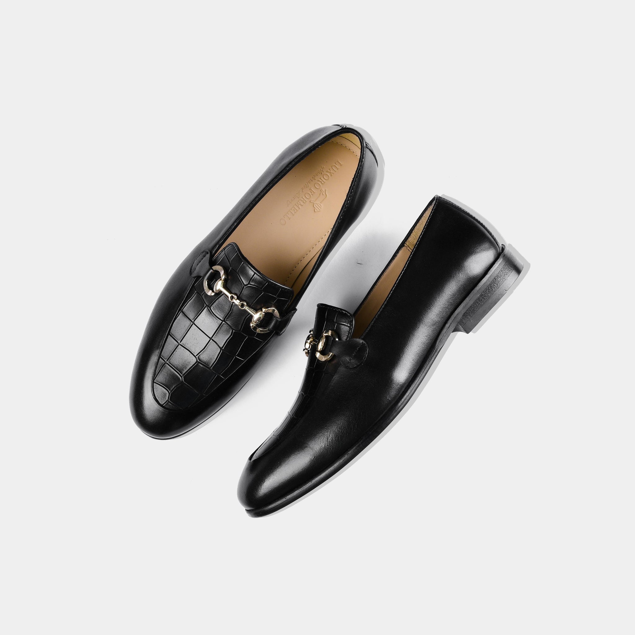 Pair of Damian Black Loafers, featuring a gold accent across the vamp, shown from above on a white background.