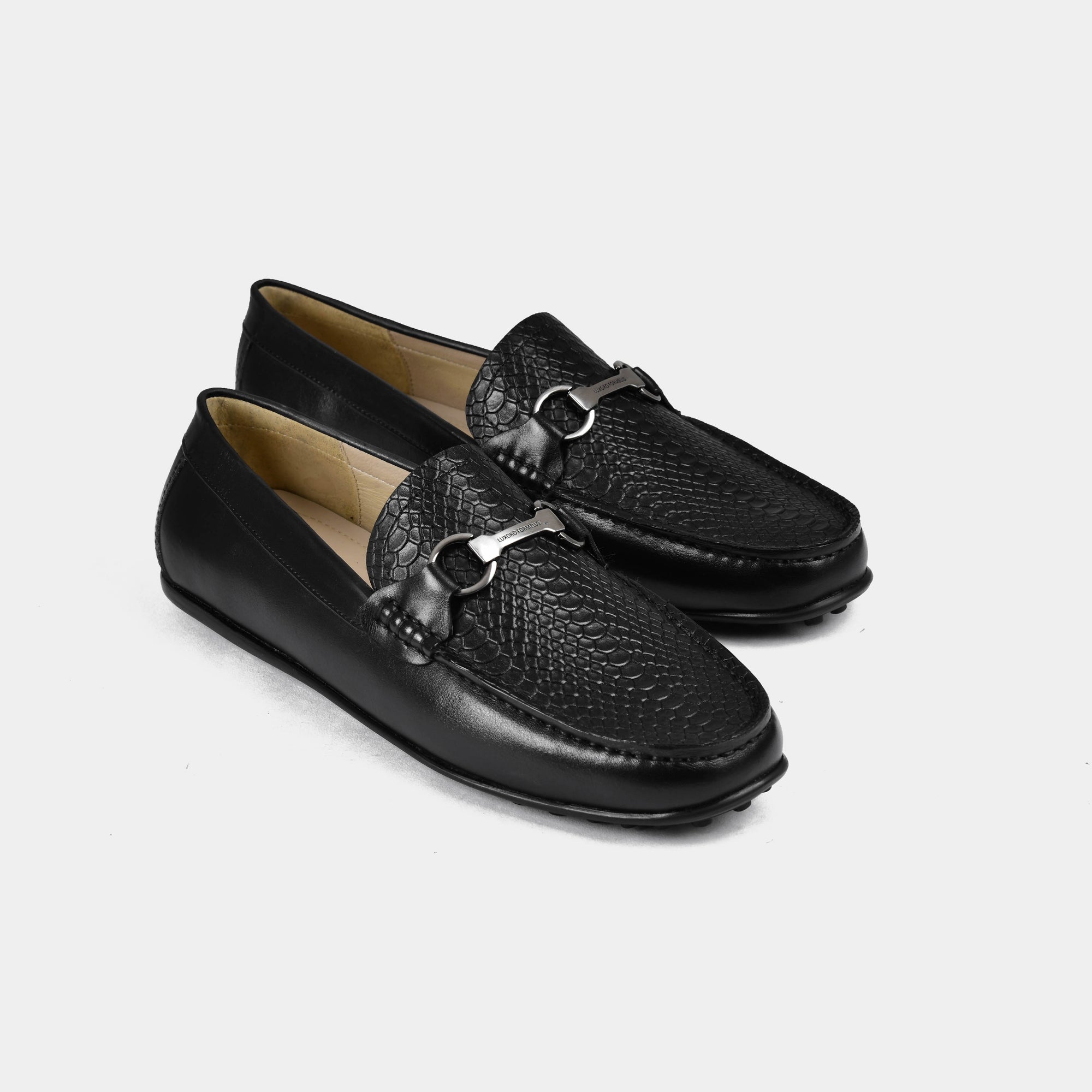 A pair of Matias Black Leather Driving Loafers with a stylish silver buckle detail, set against a white background.