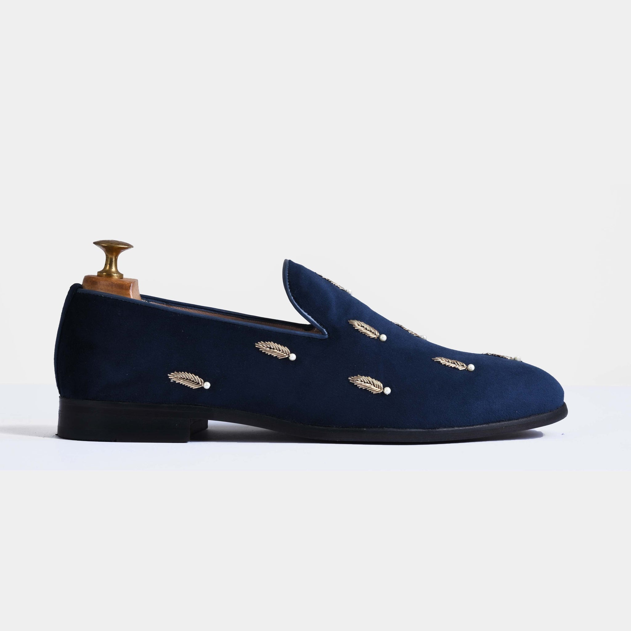 Pair of navy blue slip-on shoes with gold leaf and pearl embroidery.