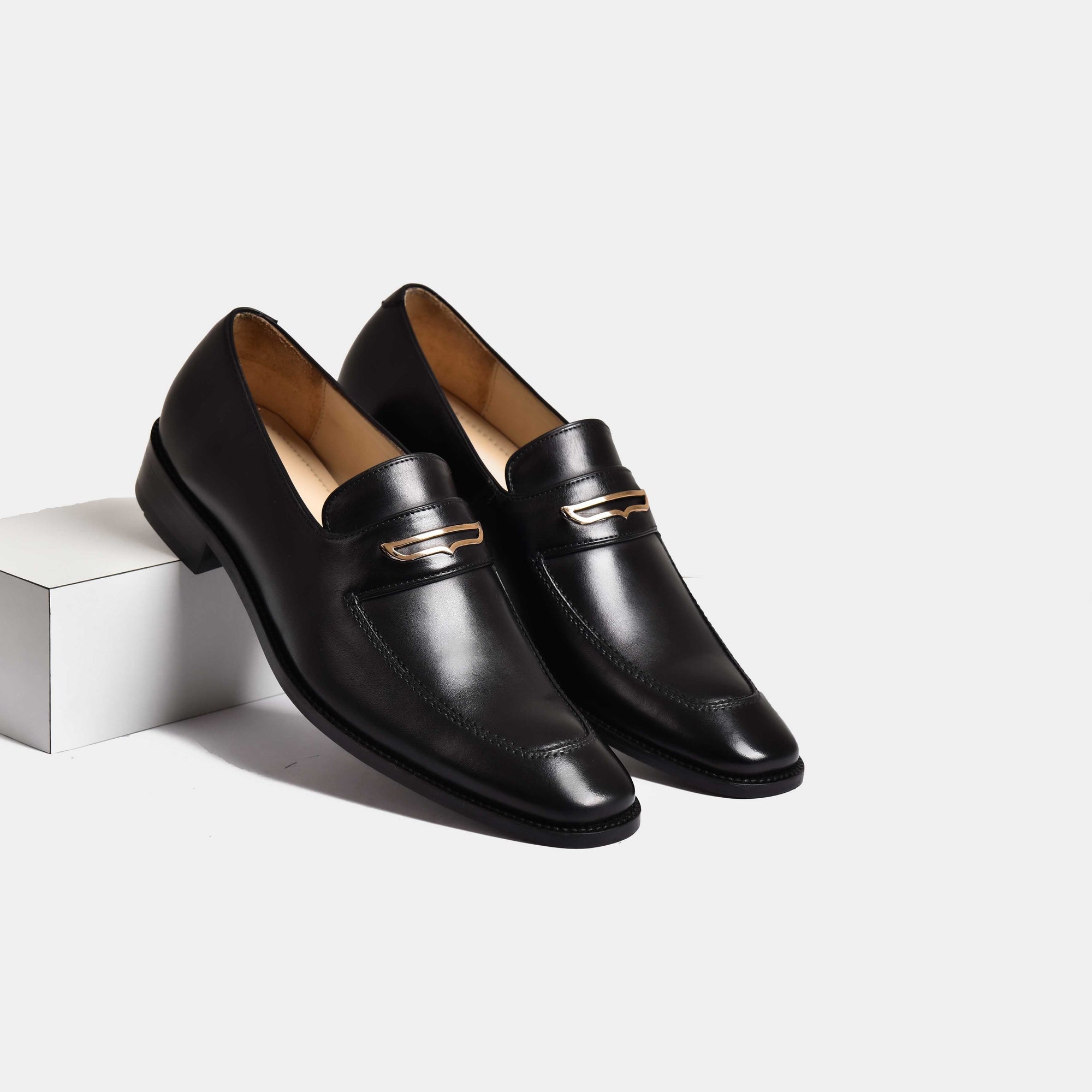 Pair of black leather Jack Black Penny Loafers with gold trim detail.