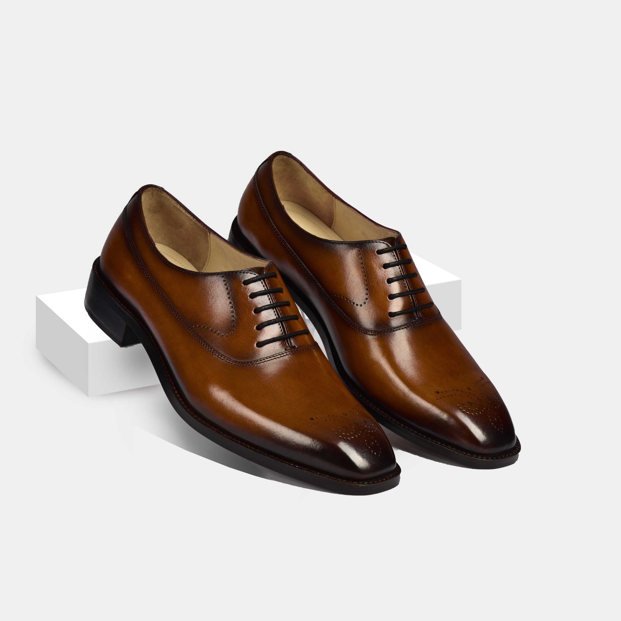 Pair of Peter Gomez Leather Laceups in brown, showcasing the stylish brogue detailing on the toe and the classic lace-up design.