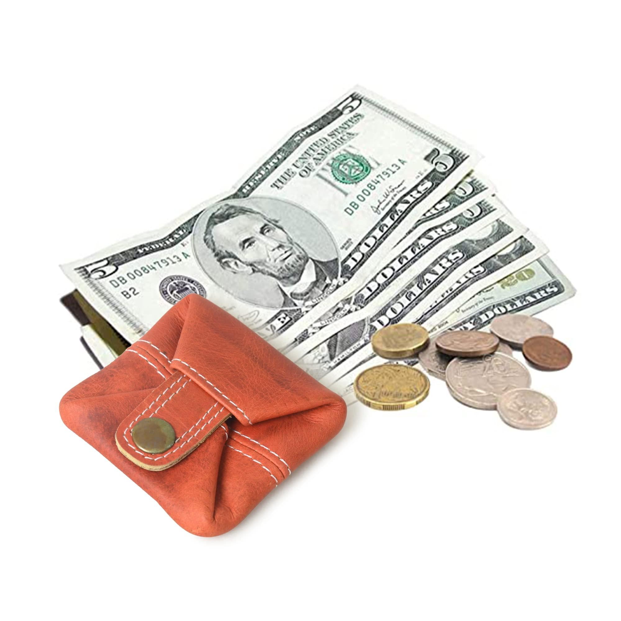 A stylish, compact, orange leather mini wallet with a snap closure, shown holding cash and coins.