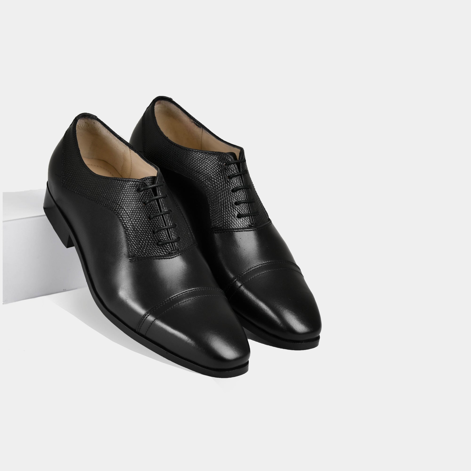 Pair of Elvio Black Leather Laceups with a textured detail, crafted from polished black leather.