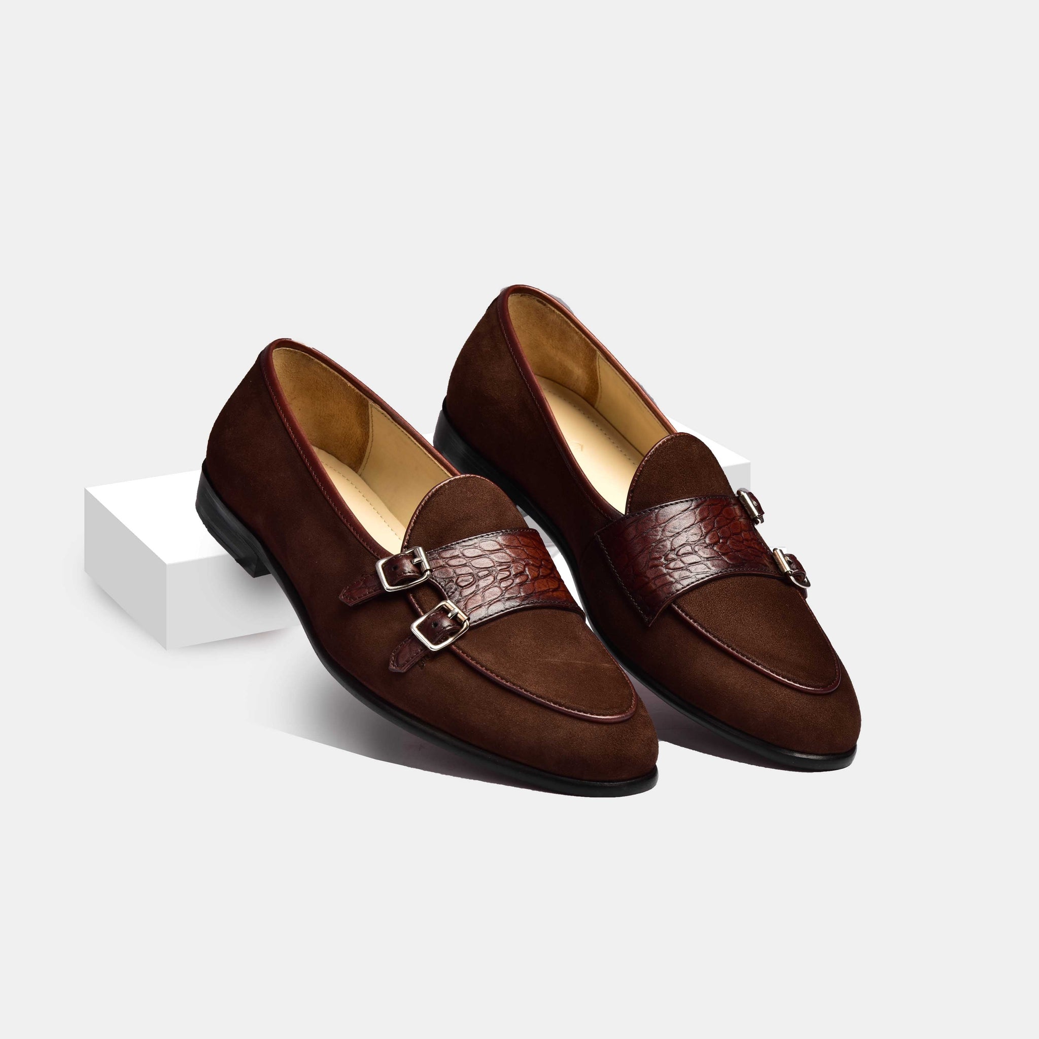 Pair of brown suede Arno loafers with double monk straps and a textured leather accent.