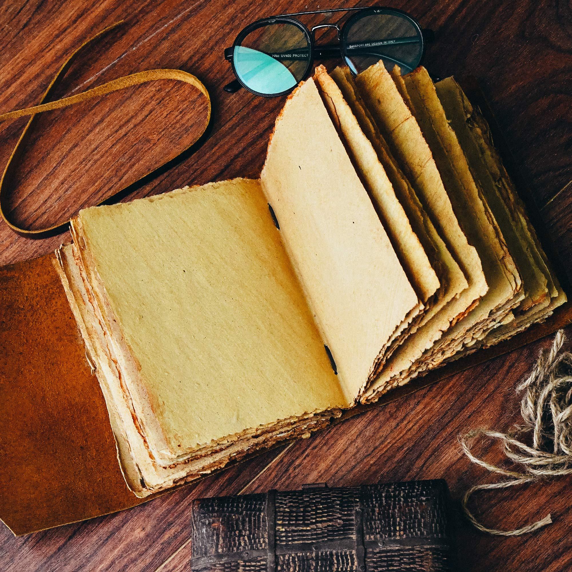 Open vintage leather journal with deckle edge paper, perfect for writing and journaling.