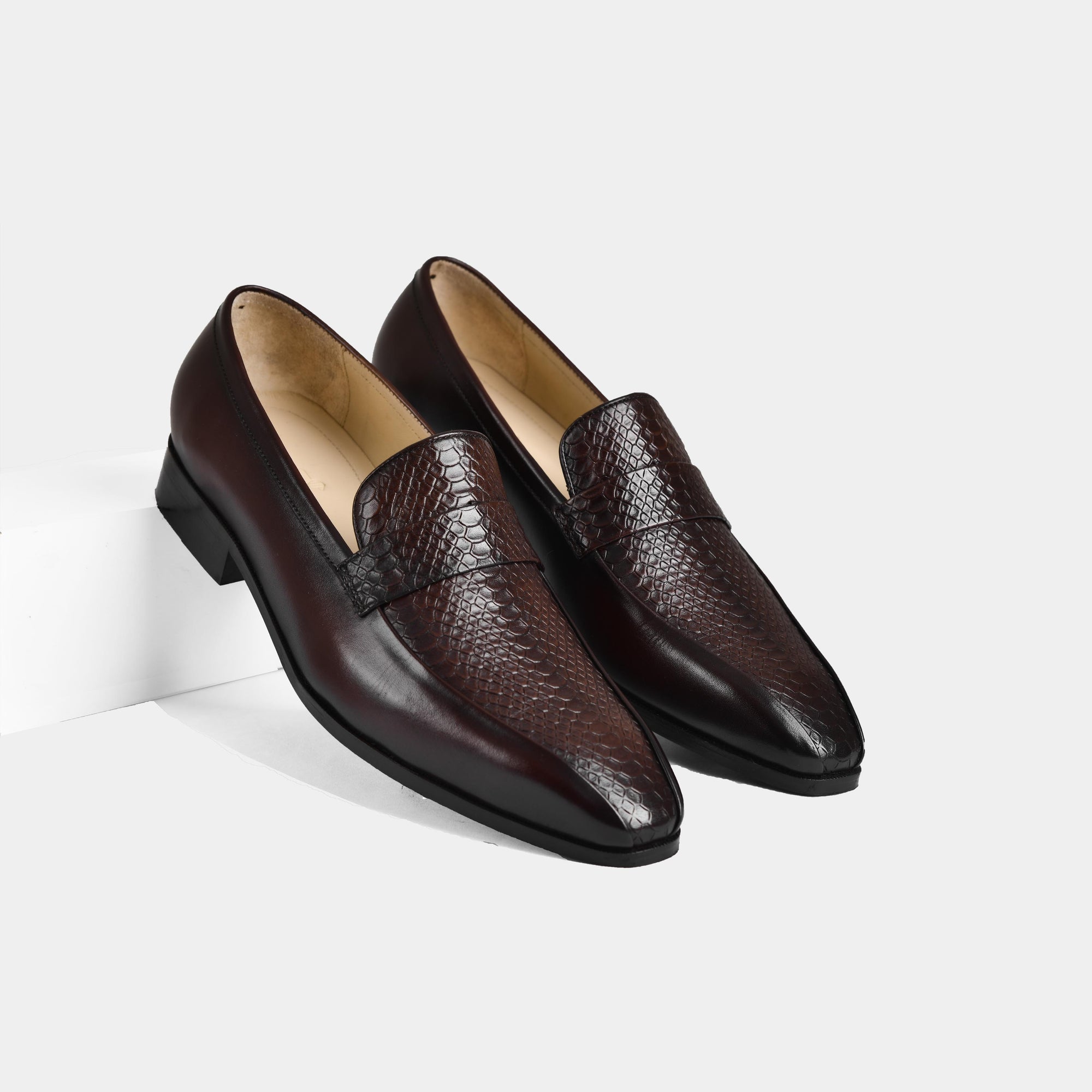 A pair of Jorge Brown Leather Loafers with a snakeskin-embossed vamp.