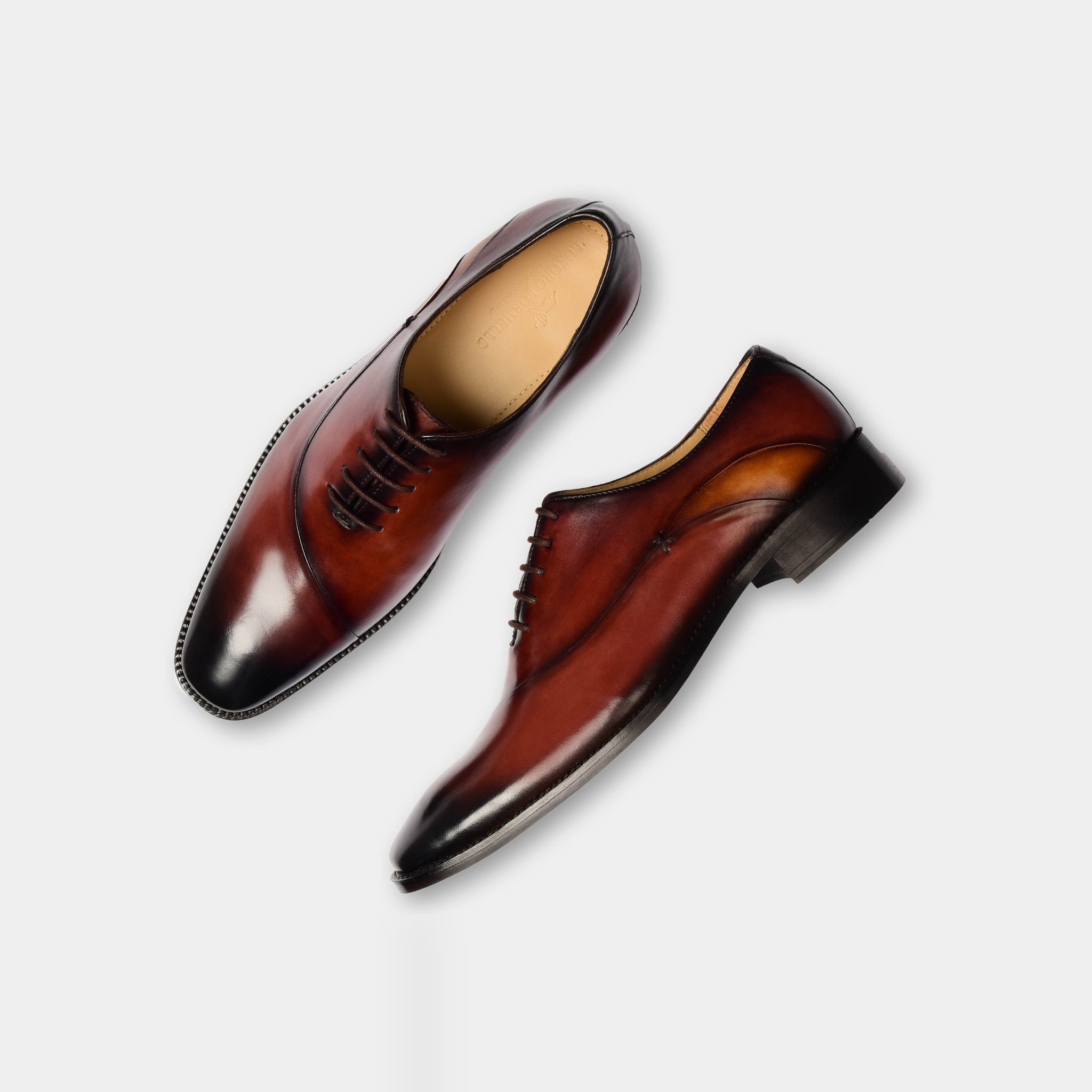 Pair of Karl Donz Leather Laceups, brown dress shoes with black laces, on a white background.