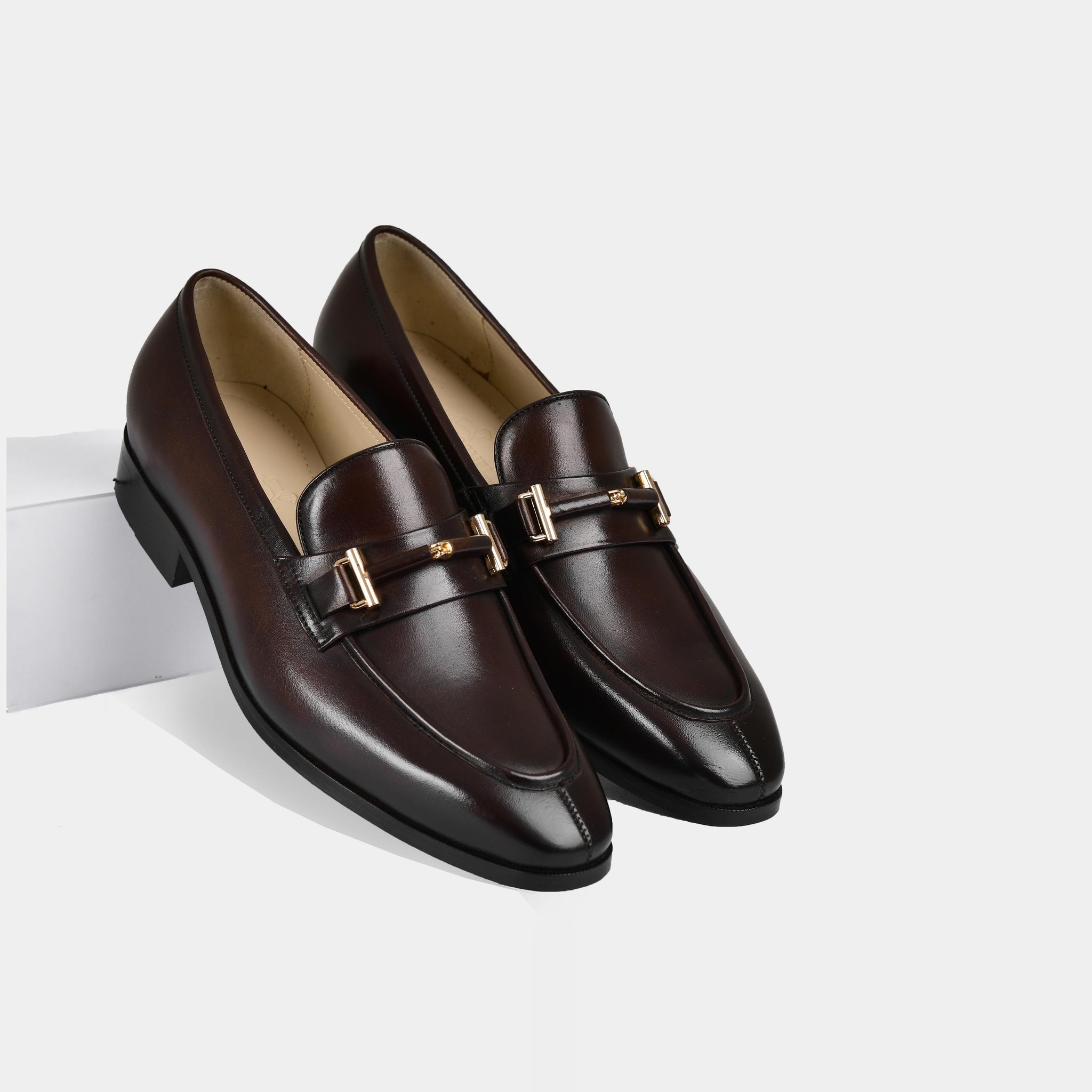 Adelmo obsidian brown leather loafers with a gold buckle detail.