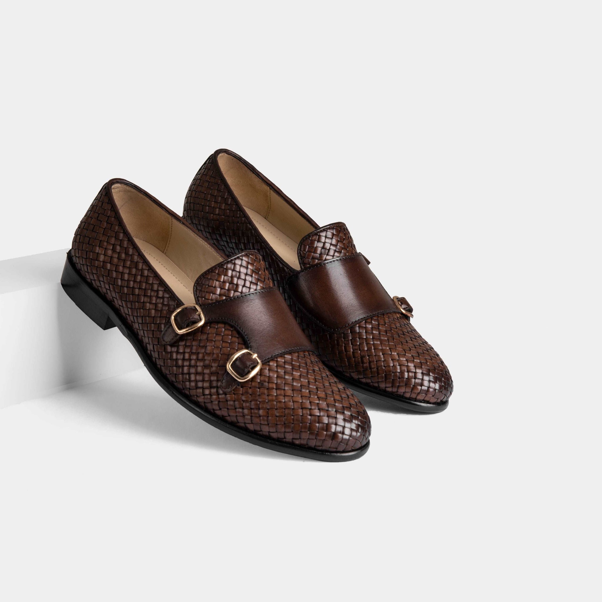 Pair of Ciro Weaved Brown Leather Monk Straps with woven design and double buckle closure.