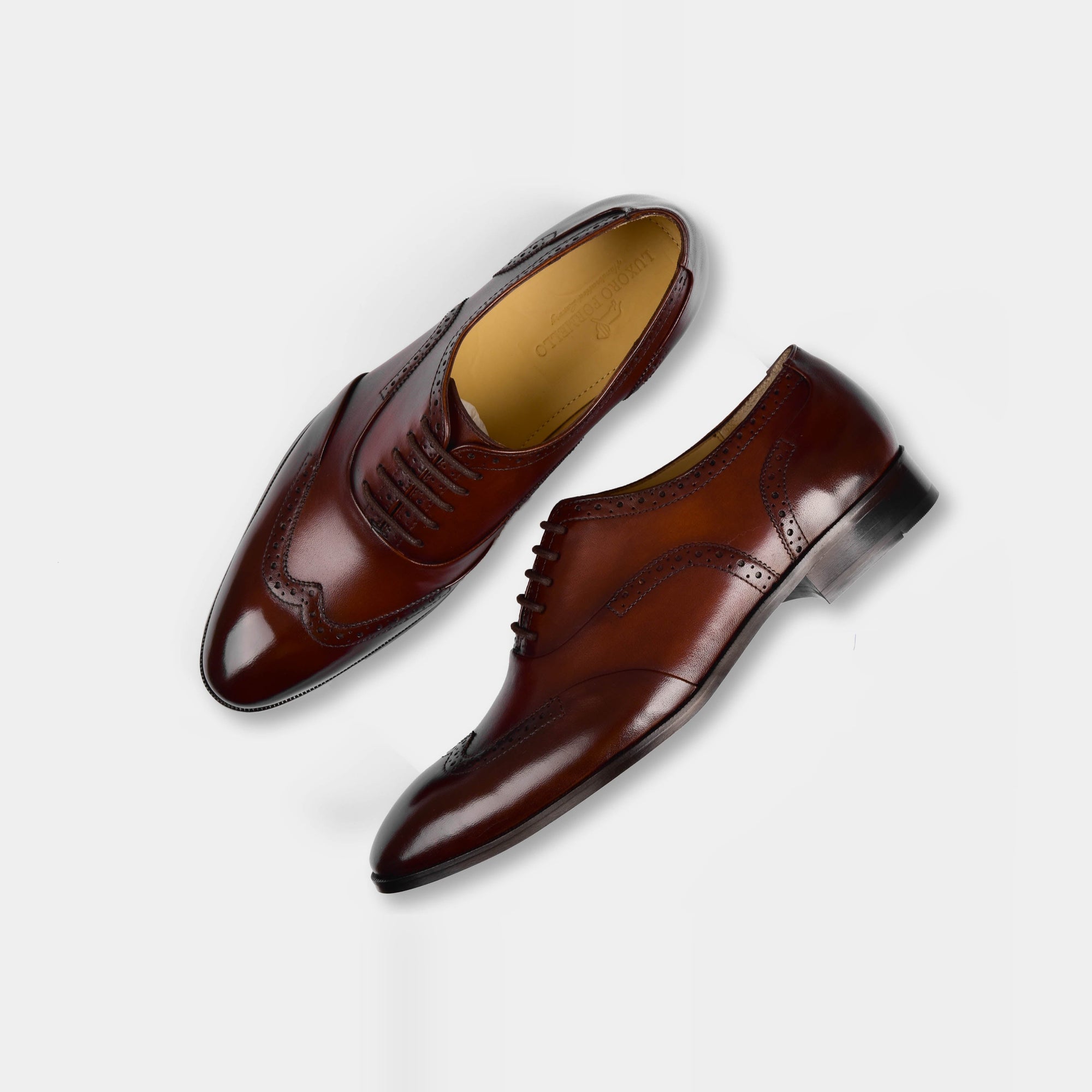 Pair of Kanor Tabaco Leather Laceups, a stylish brown dress shoe with broguing detail, shown from above on a white background.