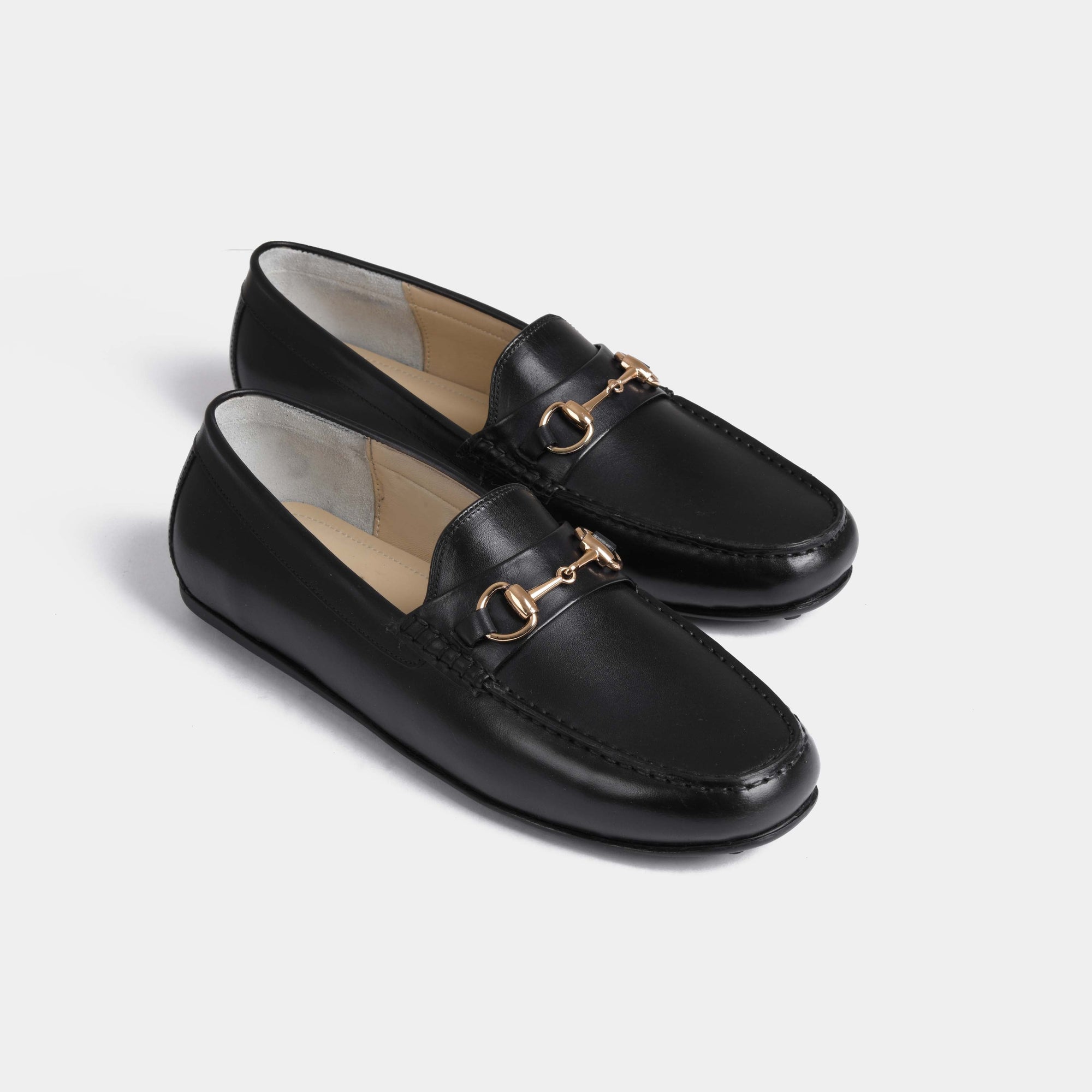 Pair of Marco Black Leather Driving Loafers with gold snaffle bit hardware.