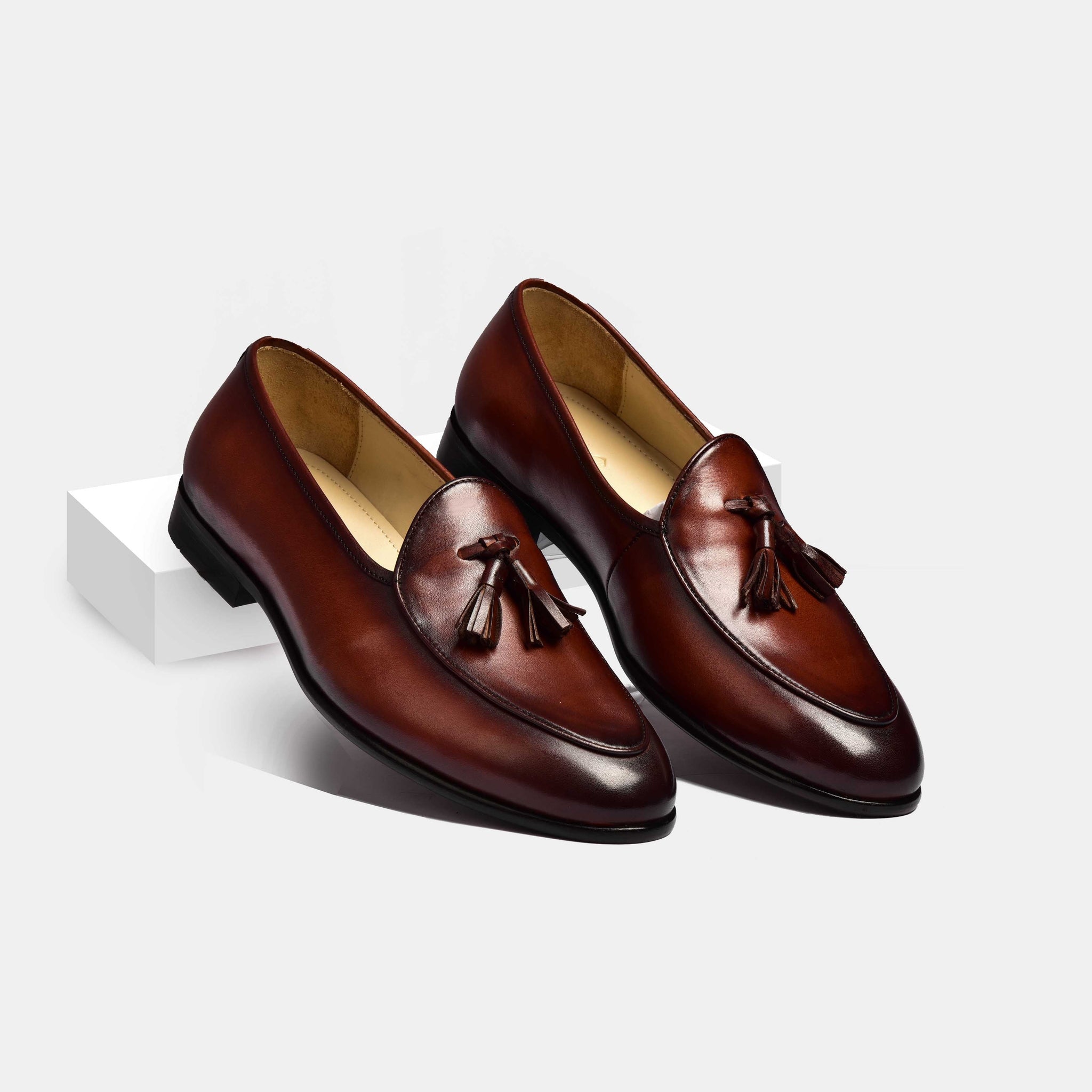 Pair of brown patina Arno loafers with classic tassels.