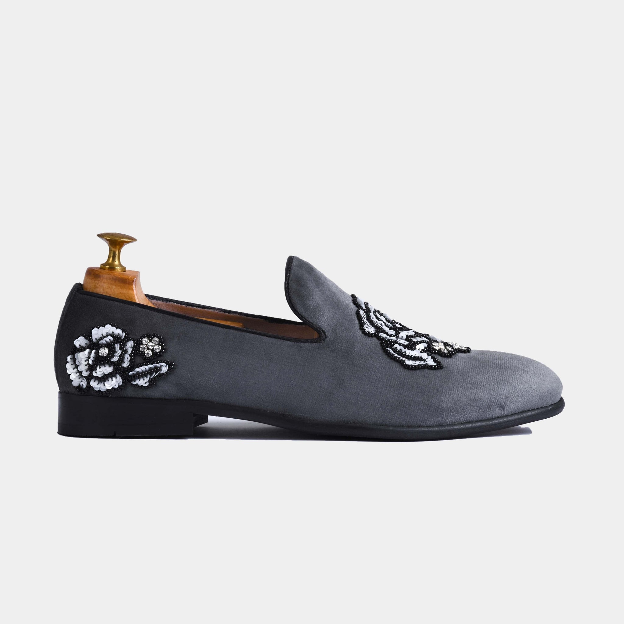 Side view of Cesar Grey Embroidered Leather Slip-Ons with black and white floral embroidery.