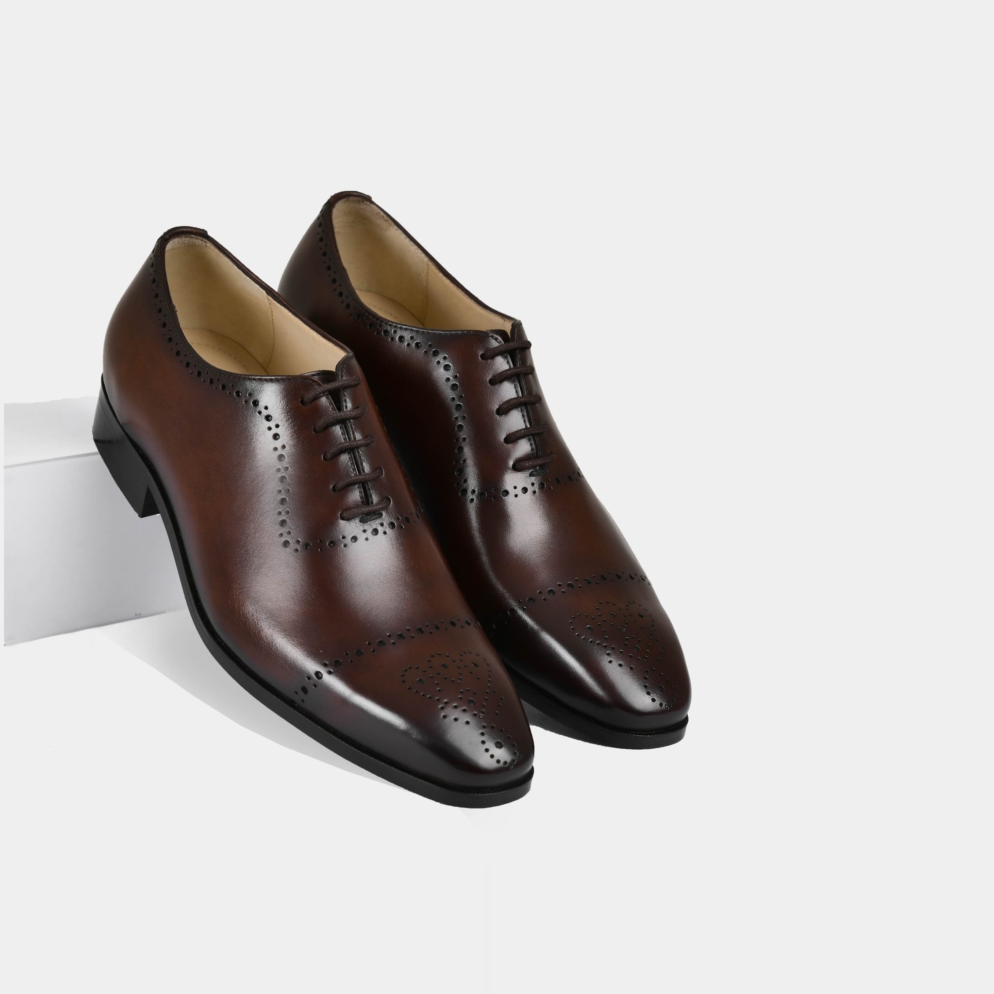 A pair of Lonzo Brown Lace Ups dress shoes with broguing detail.