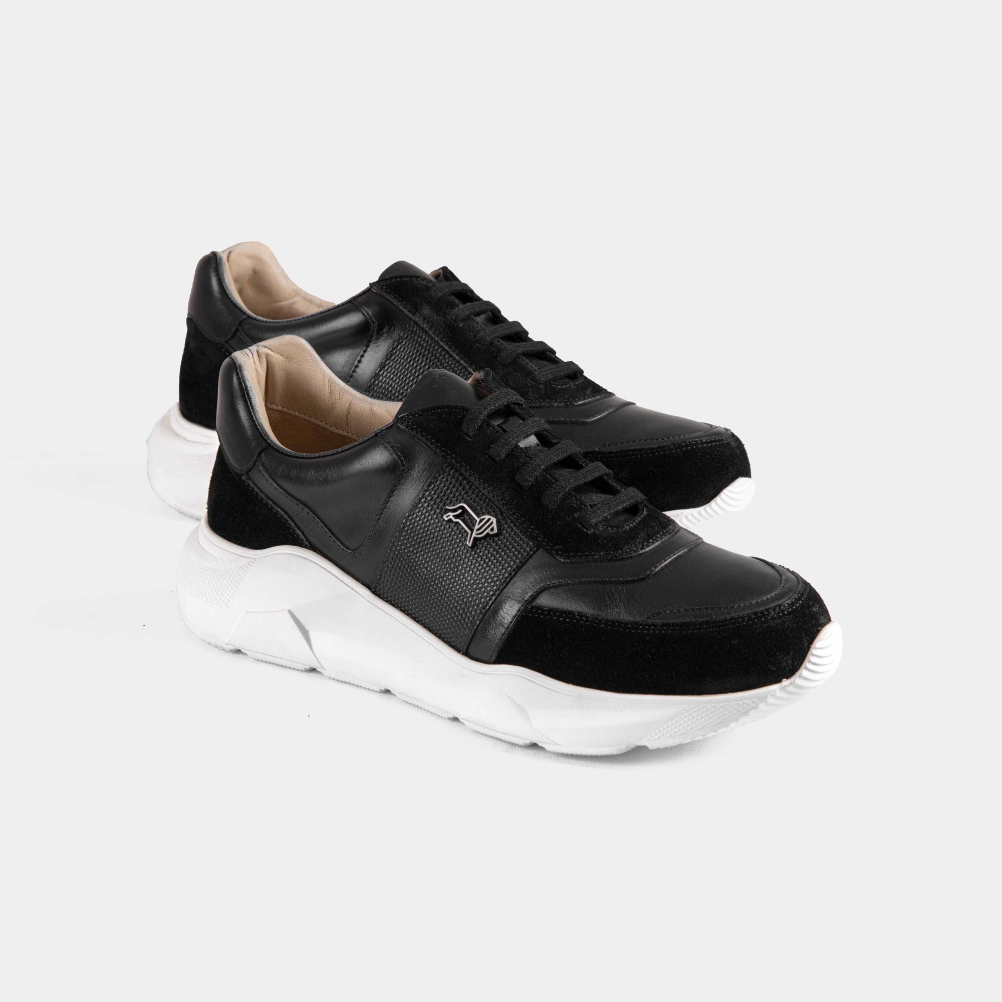 Pair of Aureo Black leather sneakers with white soles on a white background.