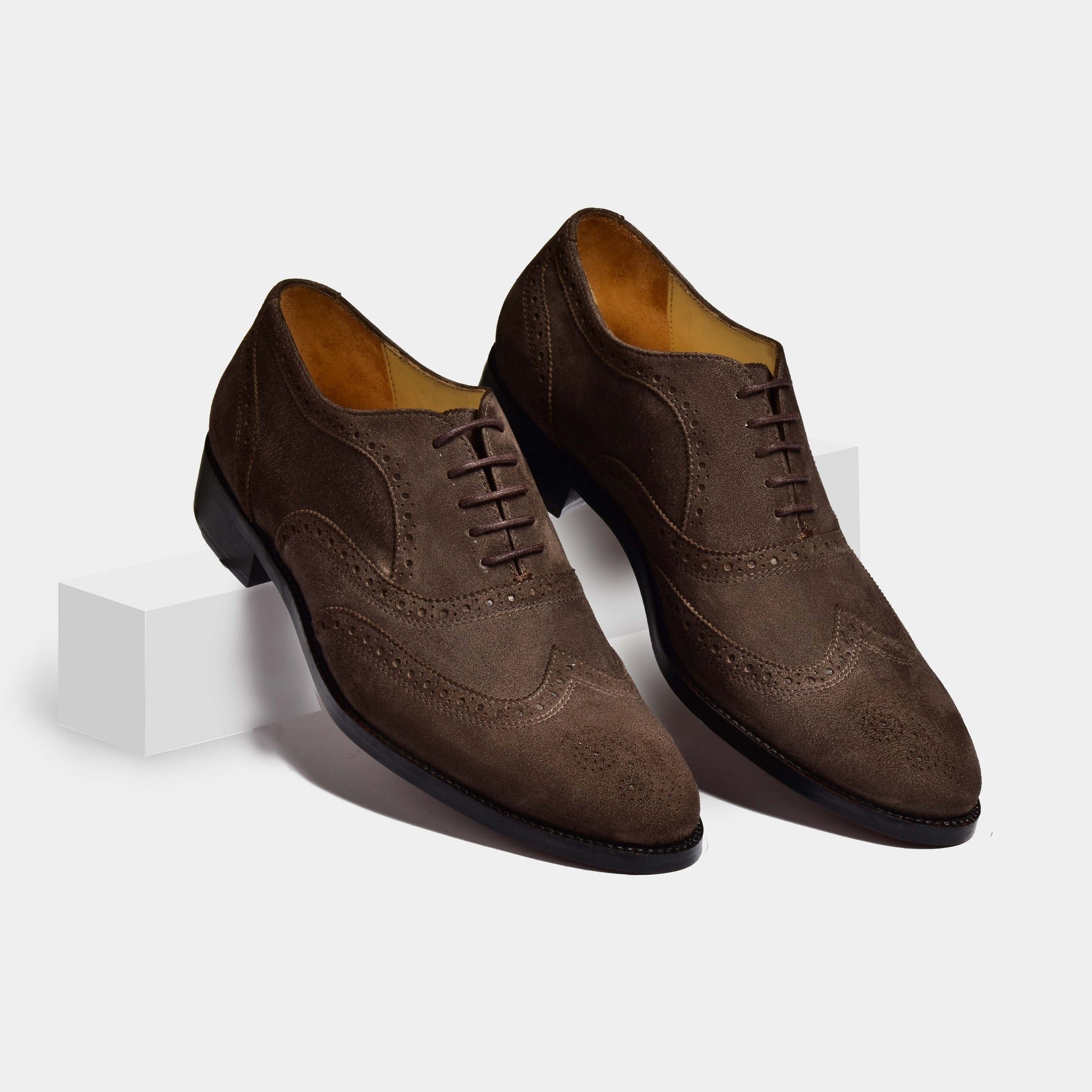 A pair of Jose Suede Brown Leather Laceups with brogue detailing on a white background.