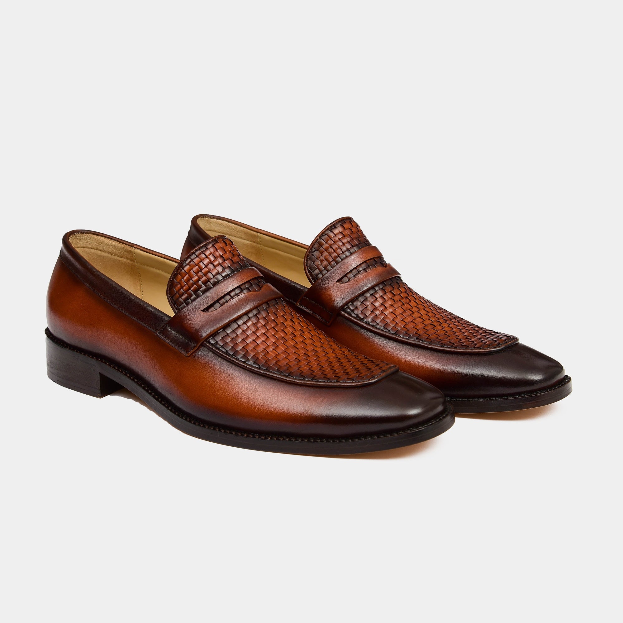 A pair of The Harold Leather Loafers in brown leather with a woven leather detail across the vamp.