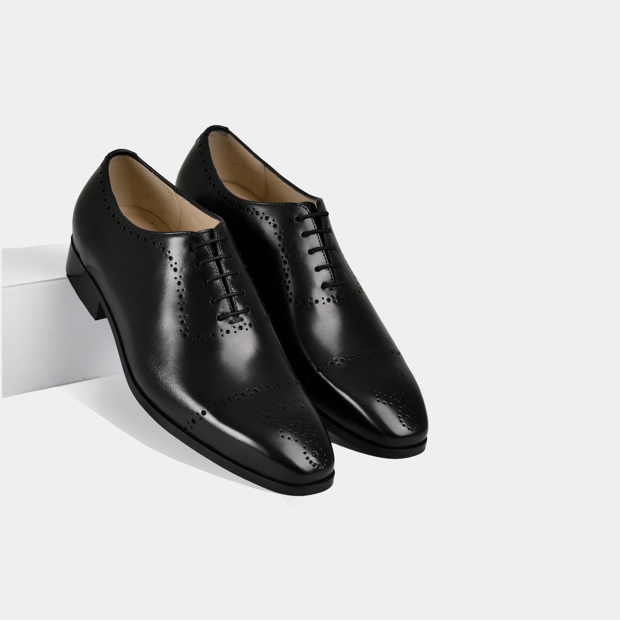 Pair of Lonzo black leather dress shoes with brogue detailing and laces.