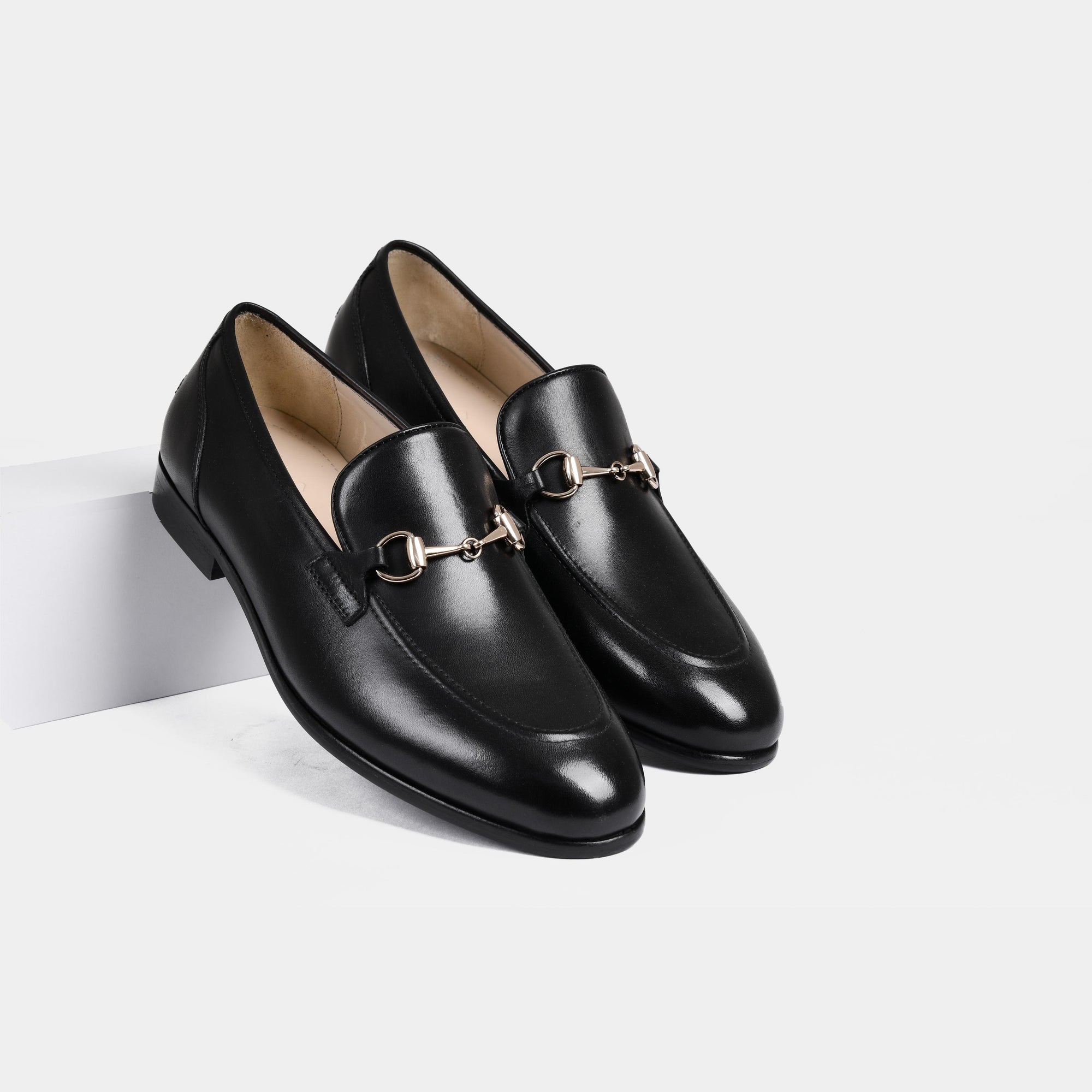 Pair of Emerald Black Leather Loafers with gold snaffle bit detail.