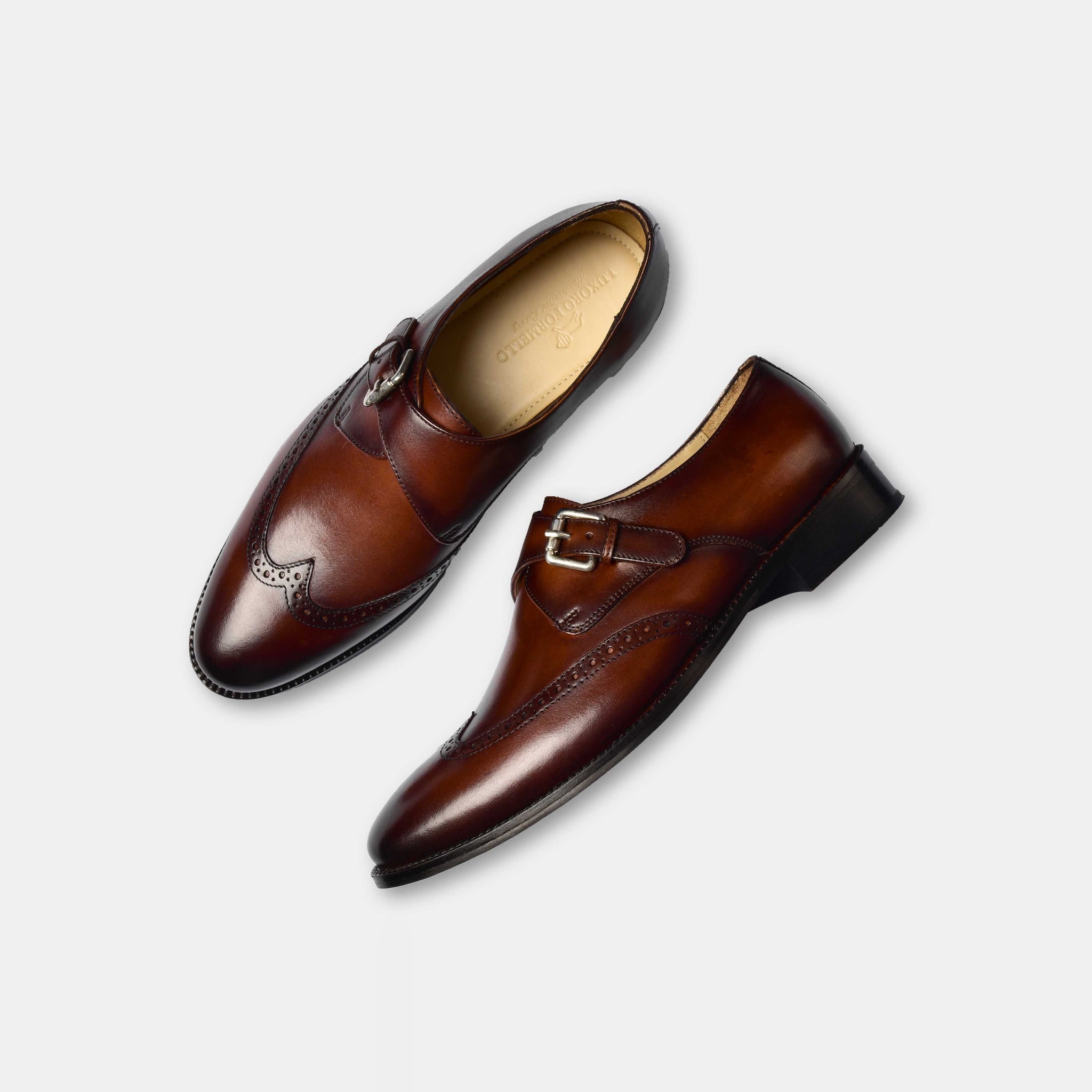 Pair of Steward Brown Single Leather Monk Strap shoes in brown leather with a wingtip design.