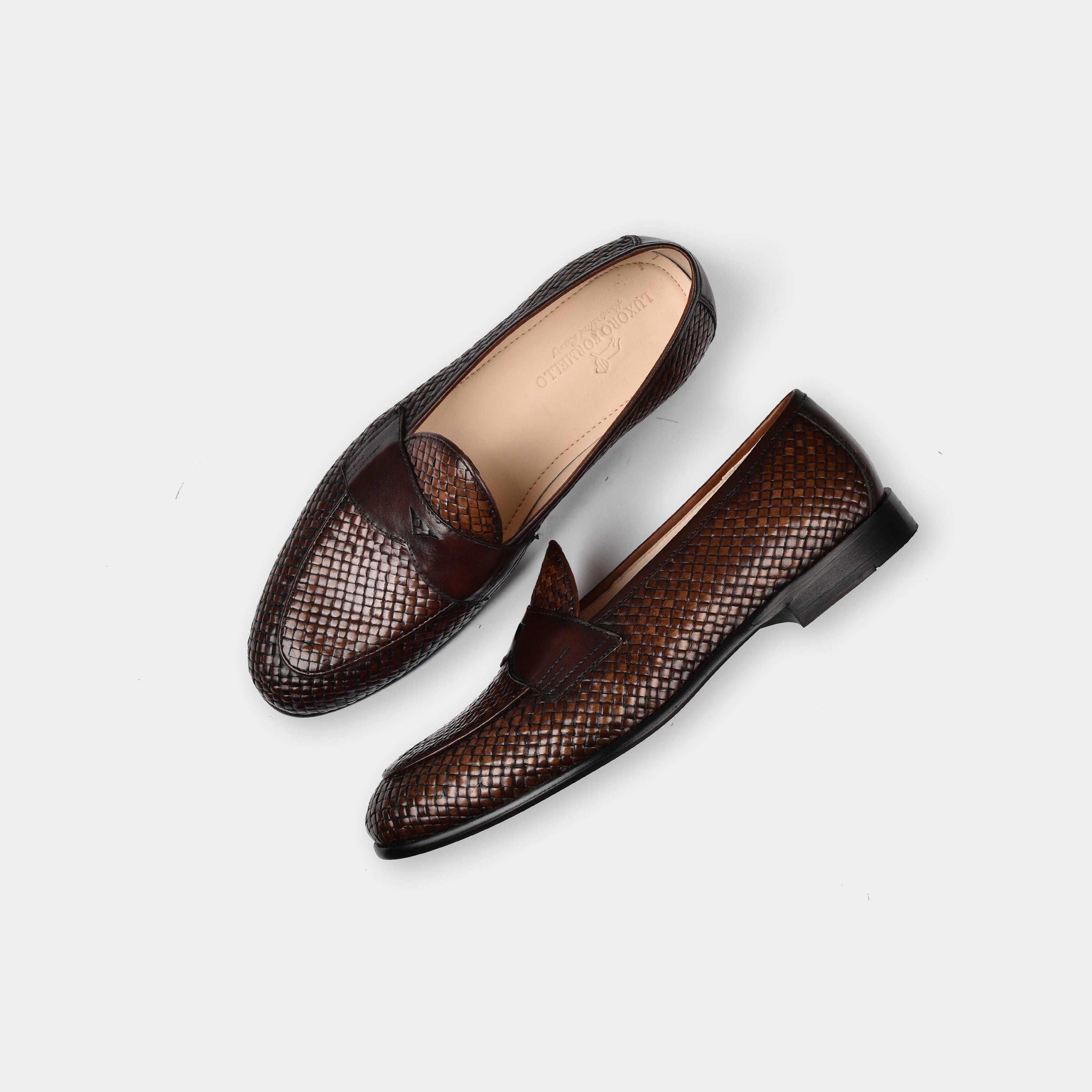 Pair of Arno Loafers in handwoven brown leather, showcasing their intricate design and classic penny loafer style.