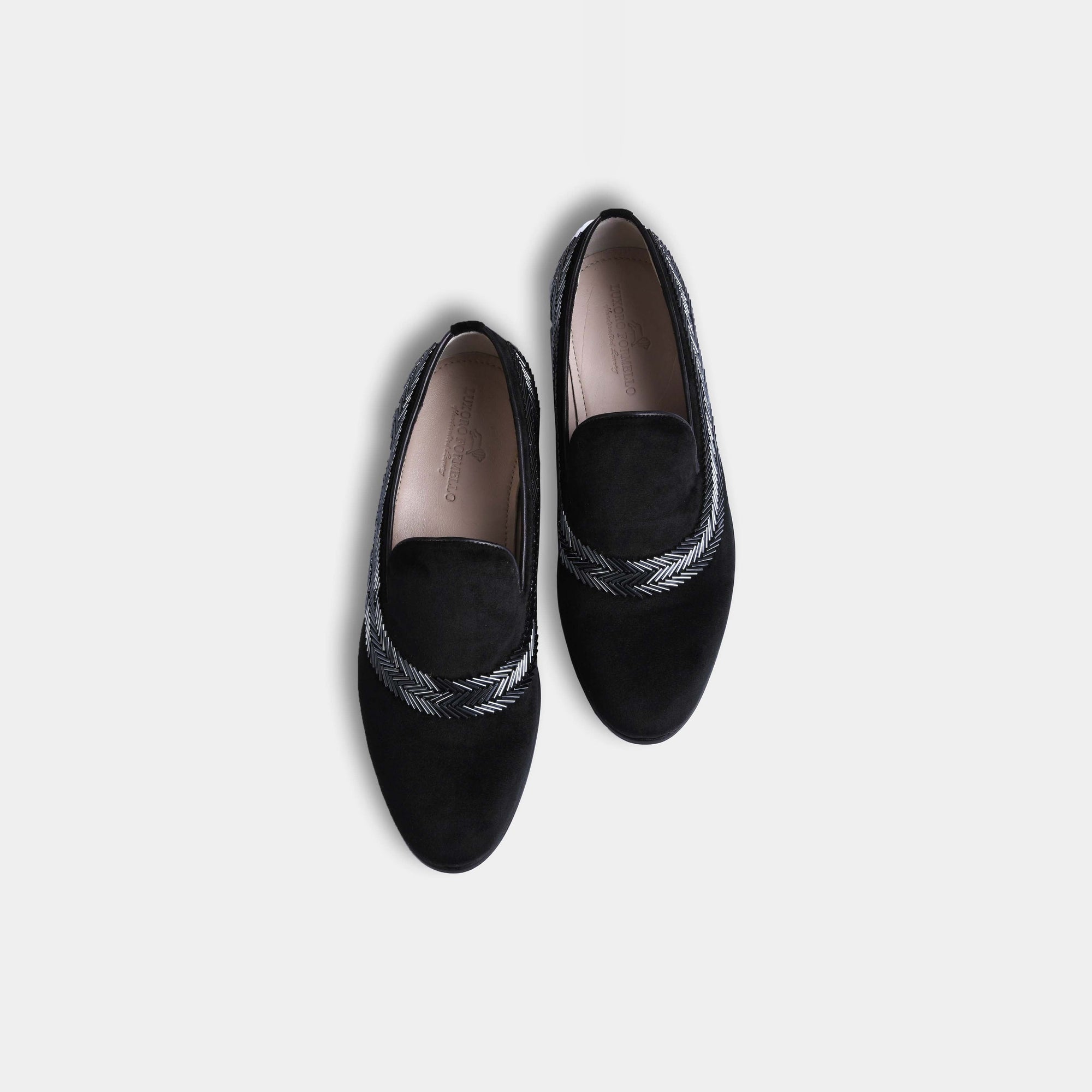 Pair of men's black velvet Alvaro slip-on loafers with silver embroidered detail and leather footbeds, shown from above.