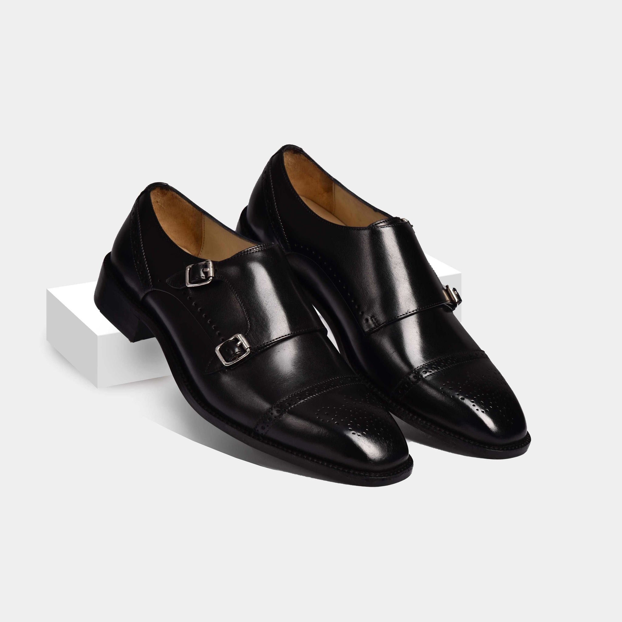 A pair of Aldrich Black Monk Leather Monk Straps on a white background.