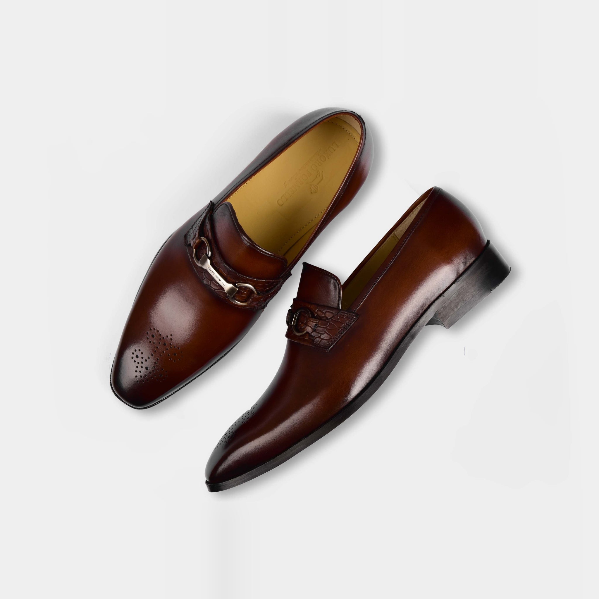 Pair of Diaz Choc Loafers in brown leather, featuring a decorative buckle and brogue detailing.