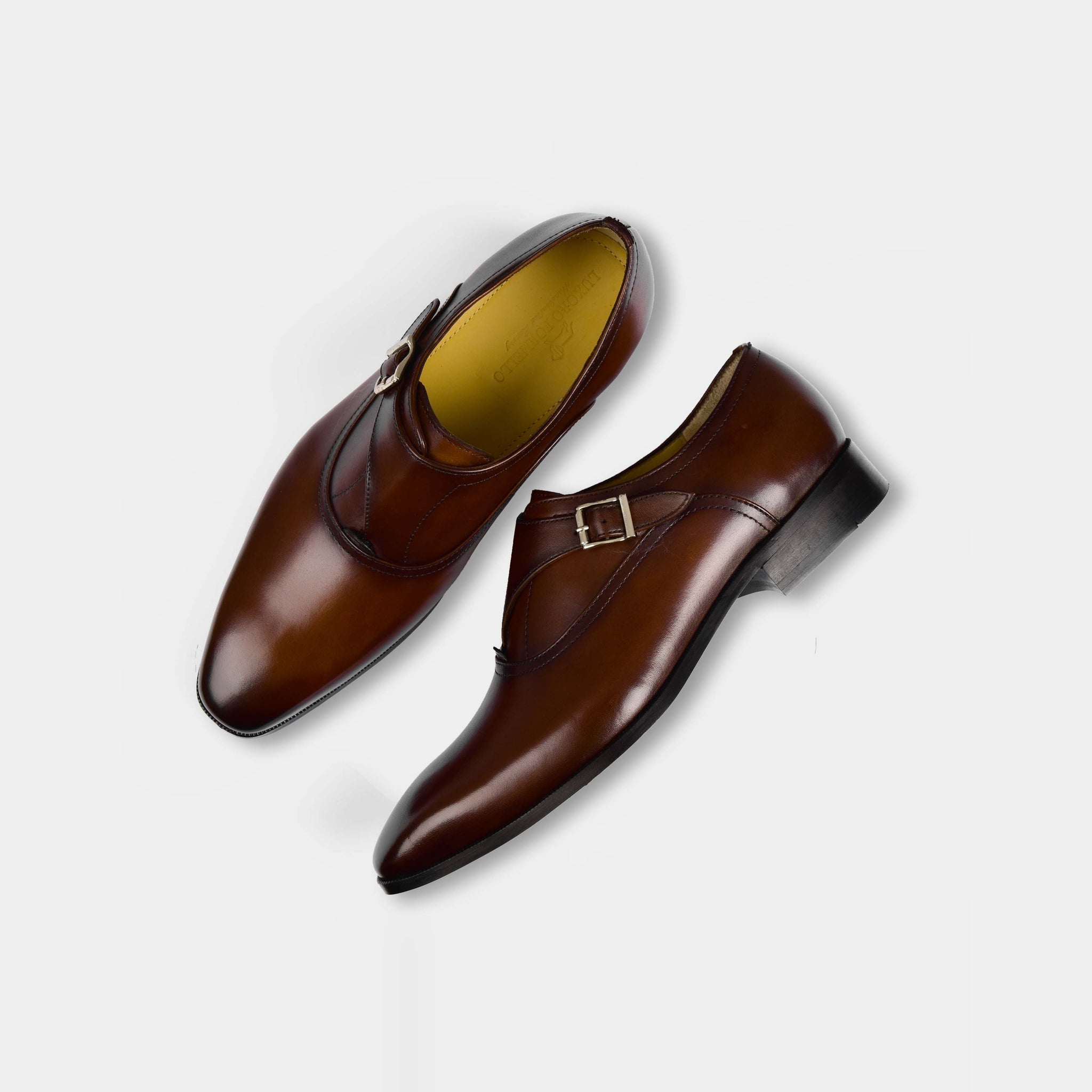 Pair of Efron Choc Monk Straps, brown leather dress shoes with buckle closures, shown from above on a white background.