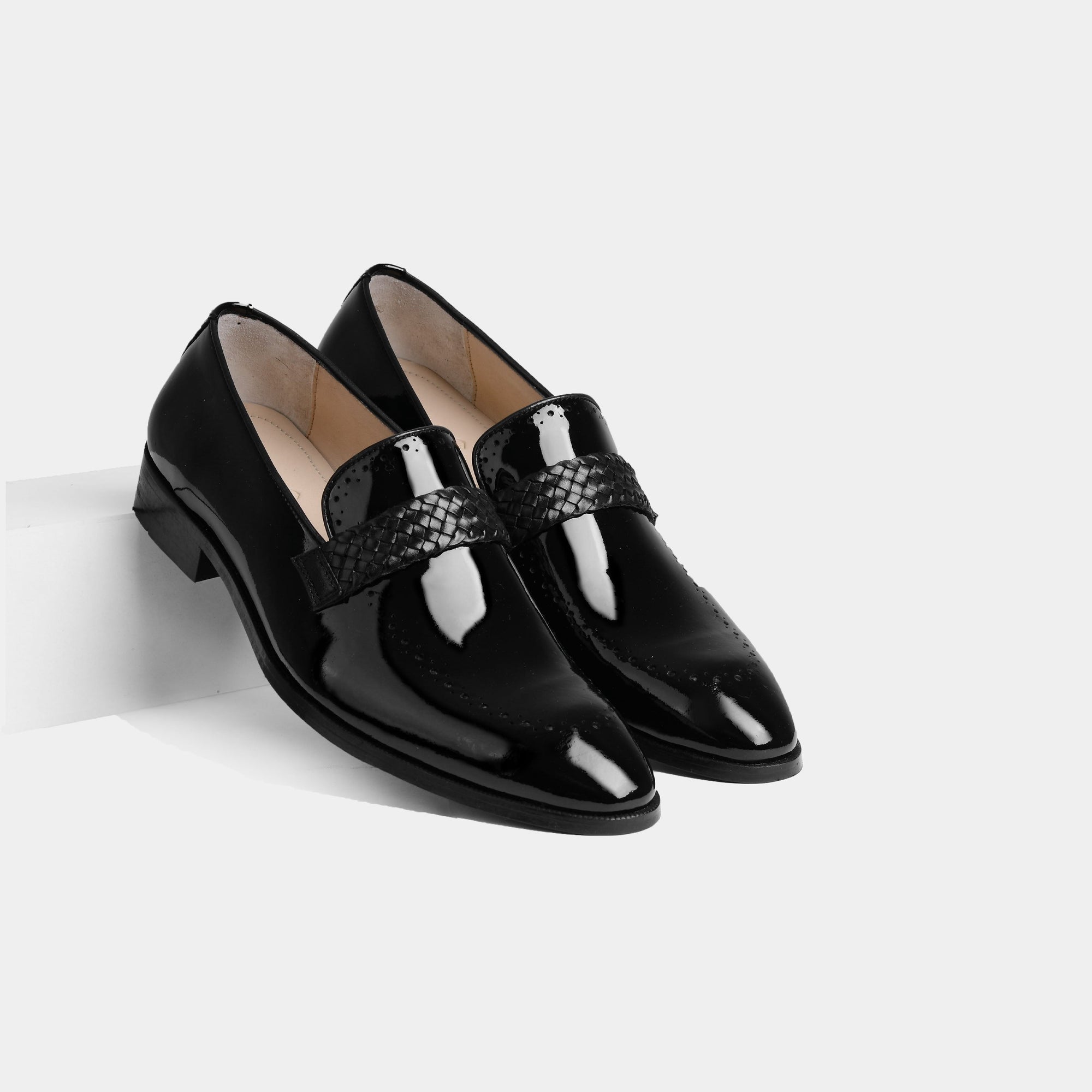 Pair of black Atilio Patent Leather Loafers with a woven strap detail.