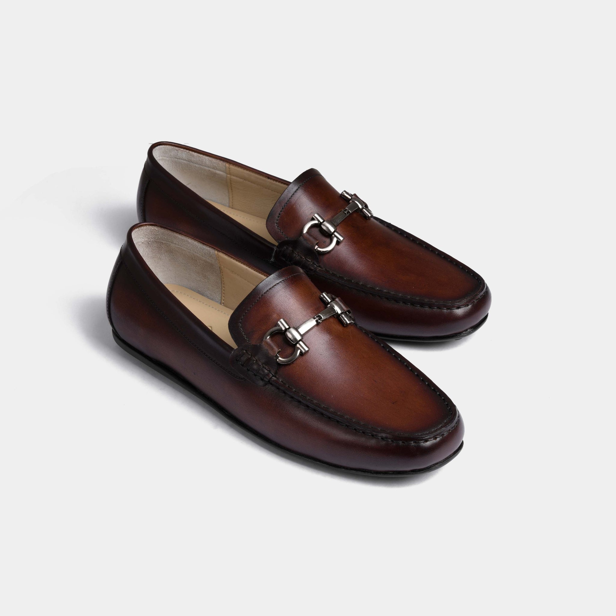 Pair of Helio Brown Leather Driving Loafers with a silver metal bit detail.