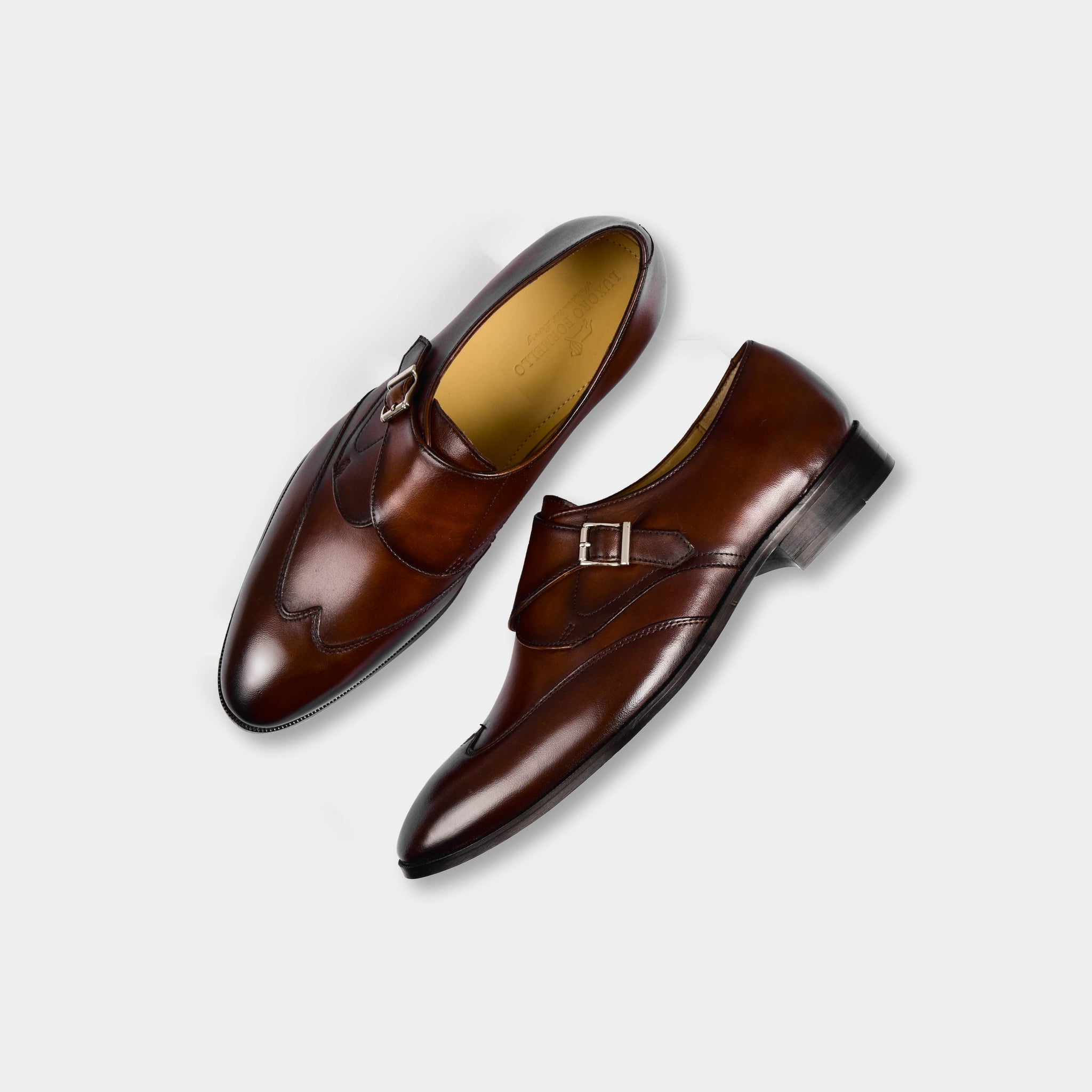 A pair of The Ondario II Leather Monk Straps in brown, showcasing the sleek design and single buckle closure of these stylish men's dress shoes.