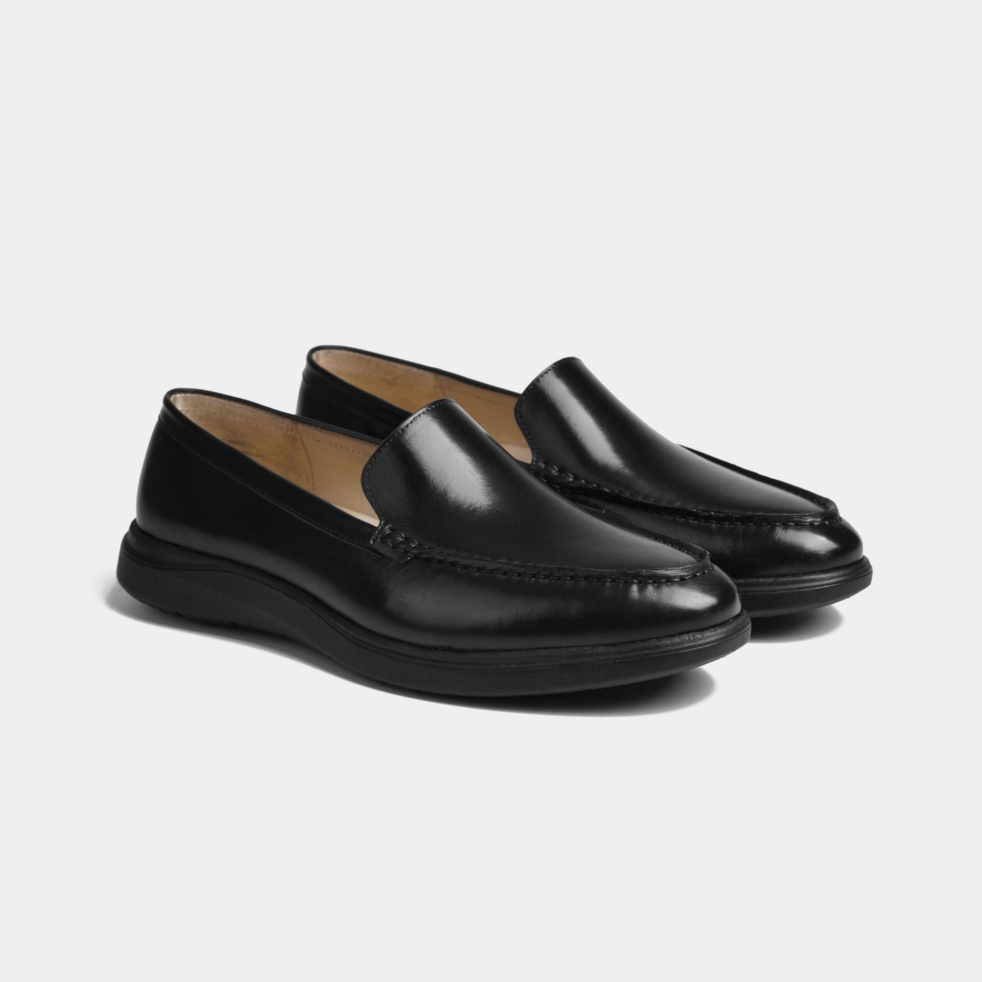 Pair of sleek black burnished leather slip-on shoes for men, featuring a flexible Aero-Flex sole for comfort.