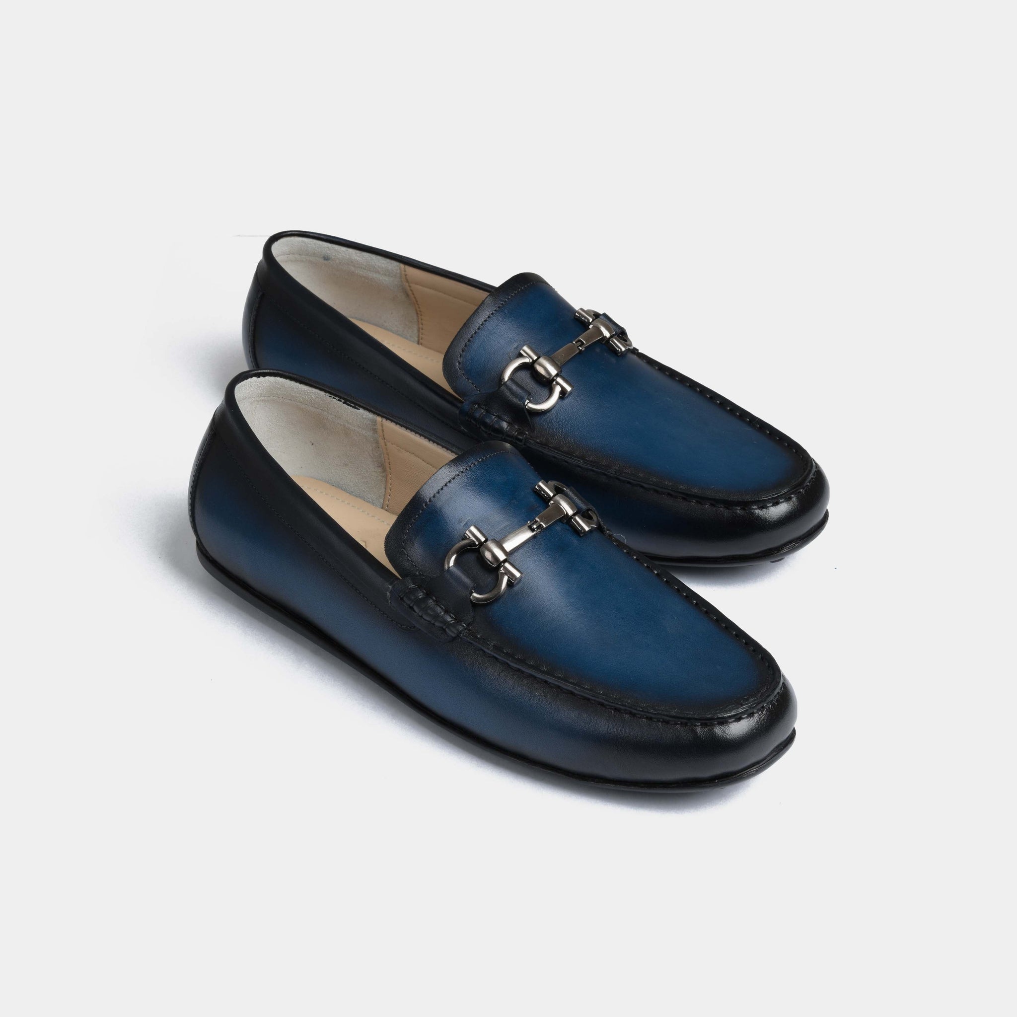 Pair of Helio Blue Leather Driving Loafers with silver buckle detail.