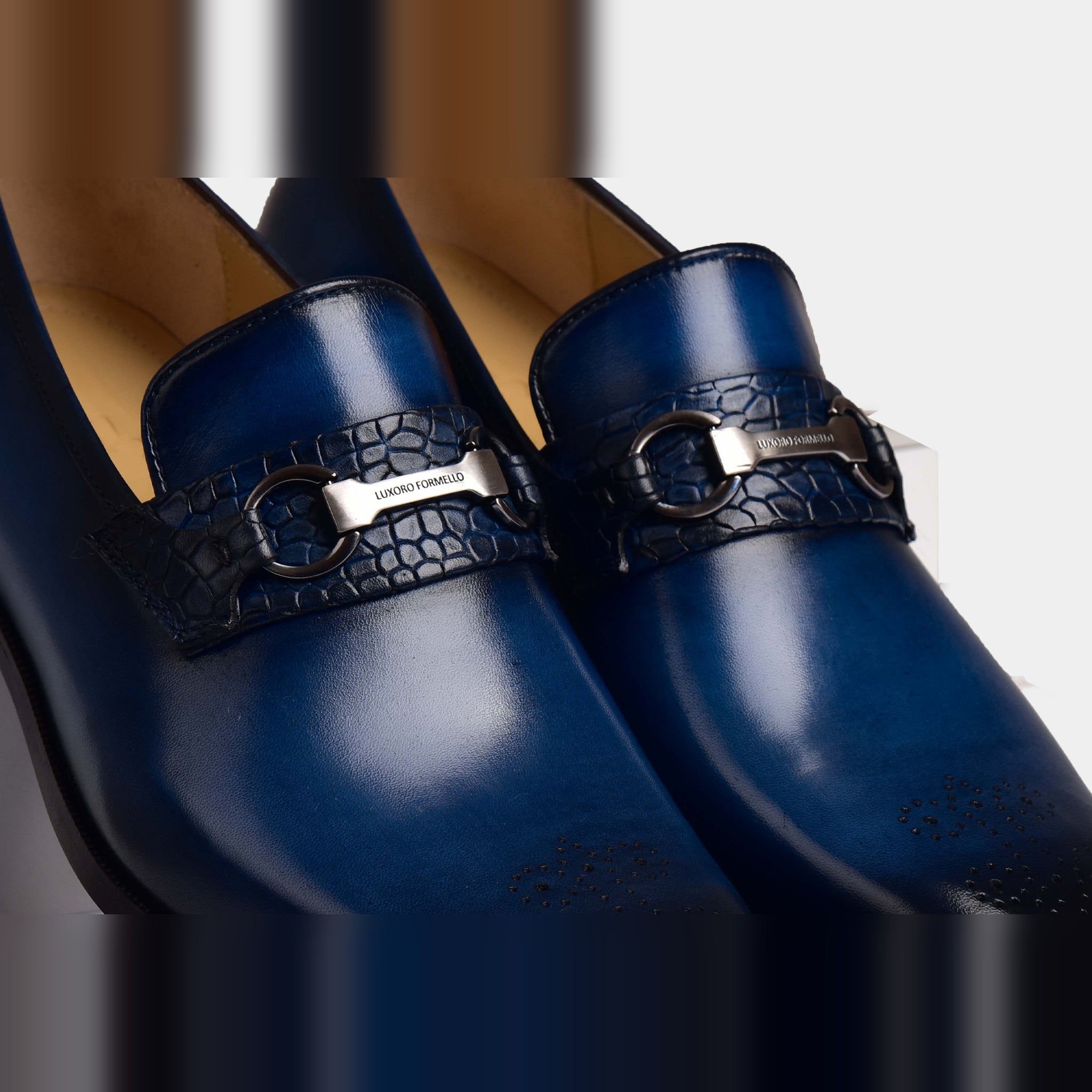 Pair of Mauricii Blue Loafers in blue leather with a textured strap and silver buckle detail.