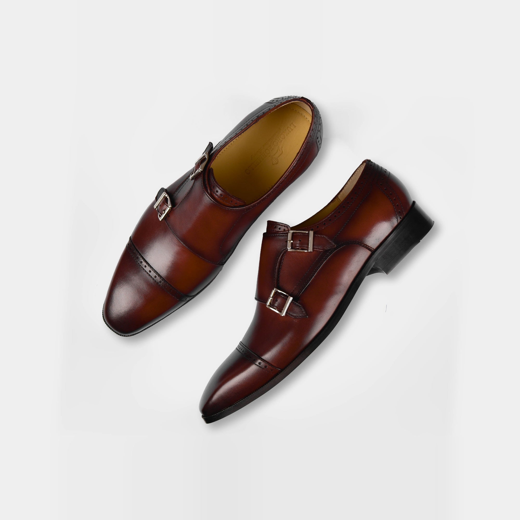 Pair of Viento Cognac Leather Monk Straps with double buckles on a white background.