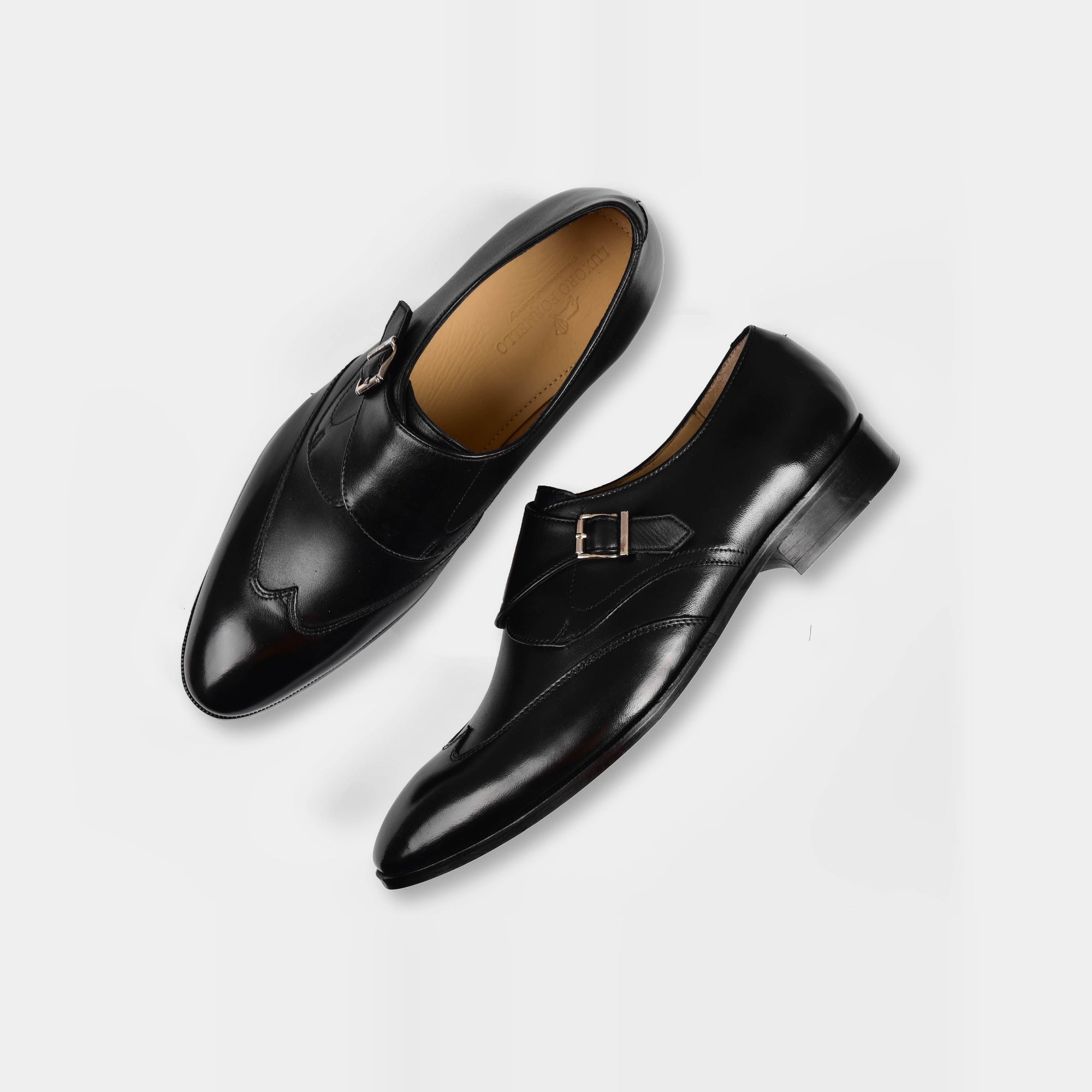 Pair of Garrett Black Leather Monk Straps shoes with silver buckles on a white background.