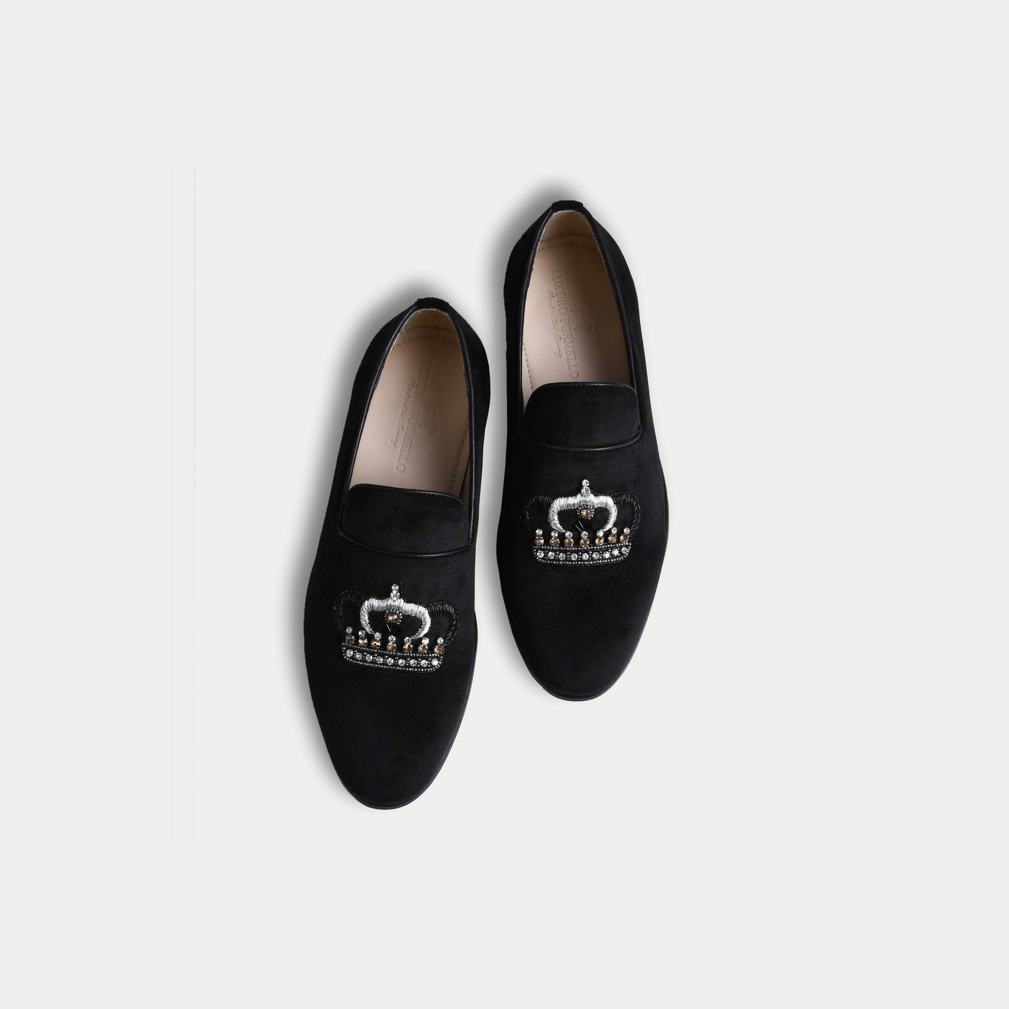 Pair of black suede Luciano slip-on shoes with embroidered crown detail.