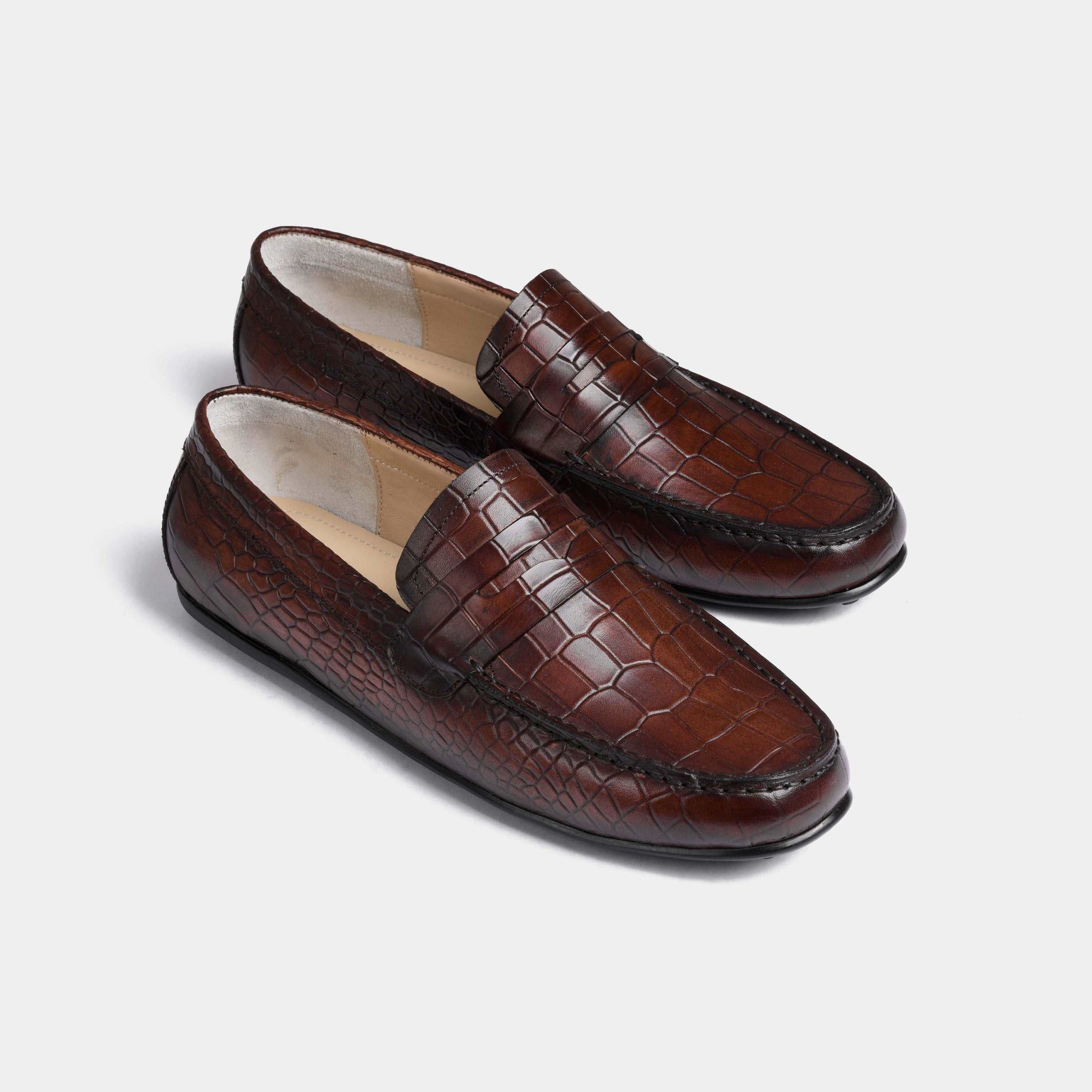 Pair of Camila Brown Leather Driving Loafers with a textured crocodile pattern.