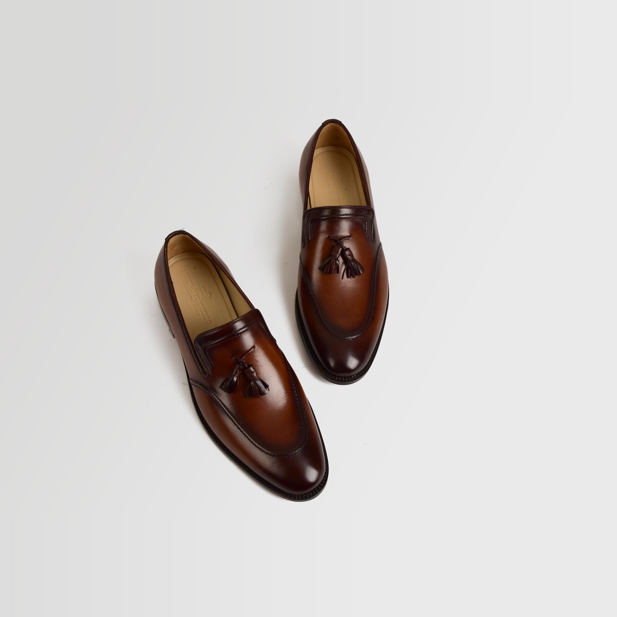 Pair of Jim Taylor Leather Loafers in brown leather with decorative tassels, viewed from above.