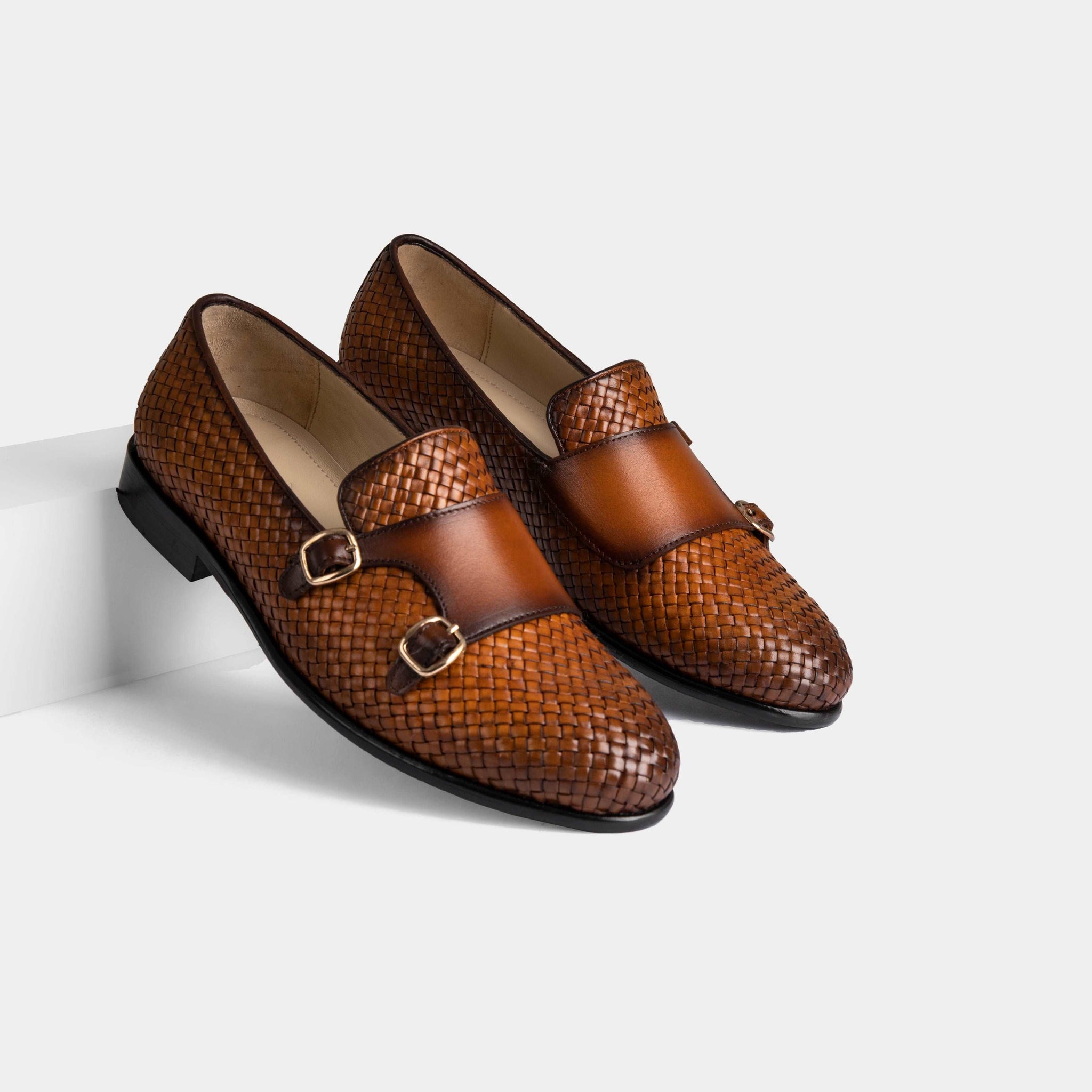 Pair of Ciro Weaved Tan Leather Monk Strap shoes with woven leather uppers and double buckle closures.