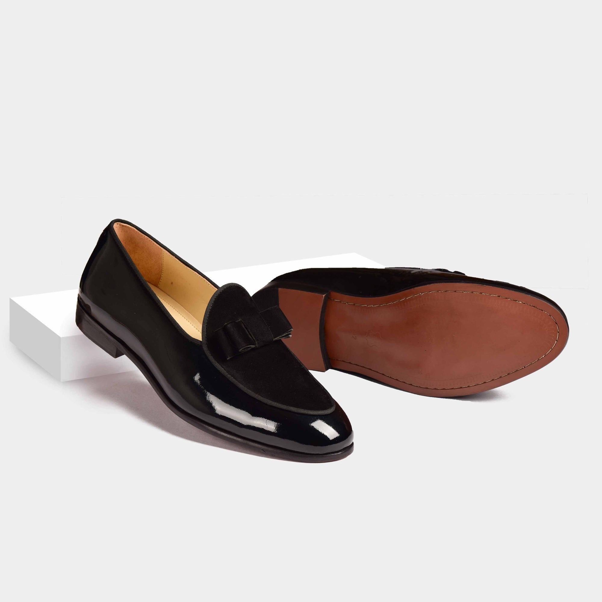 Pair of black patent calf Arno loafers with a velvet bow-tie detail.