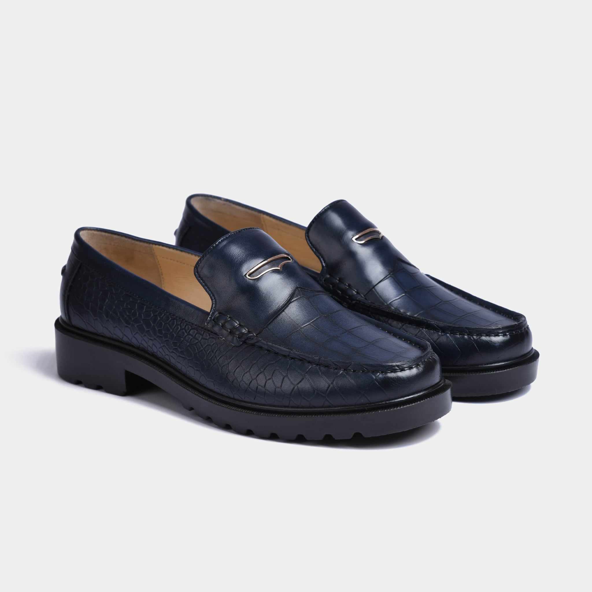 Pair of navy blue croc-embossed leather loafers with a gold trim detail and chunky Solesculpt Lite soles.