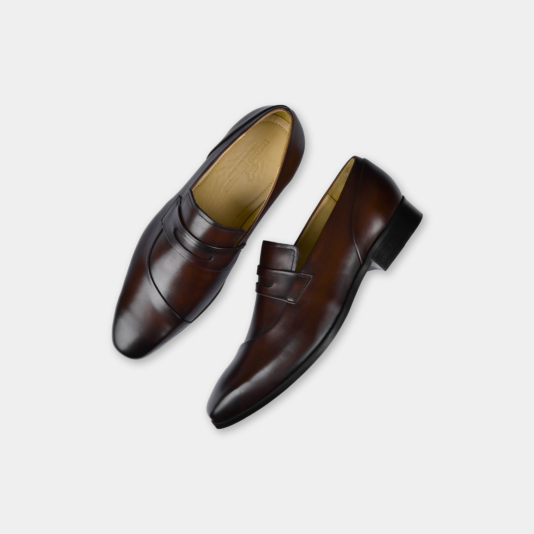 Pair of Laredo Brown Leather Loafers, showcasing their sleek design and rich brown color.