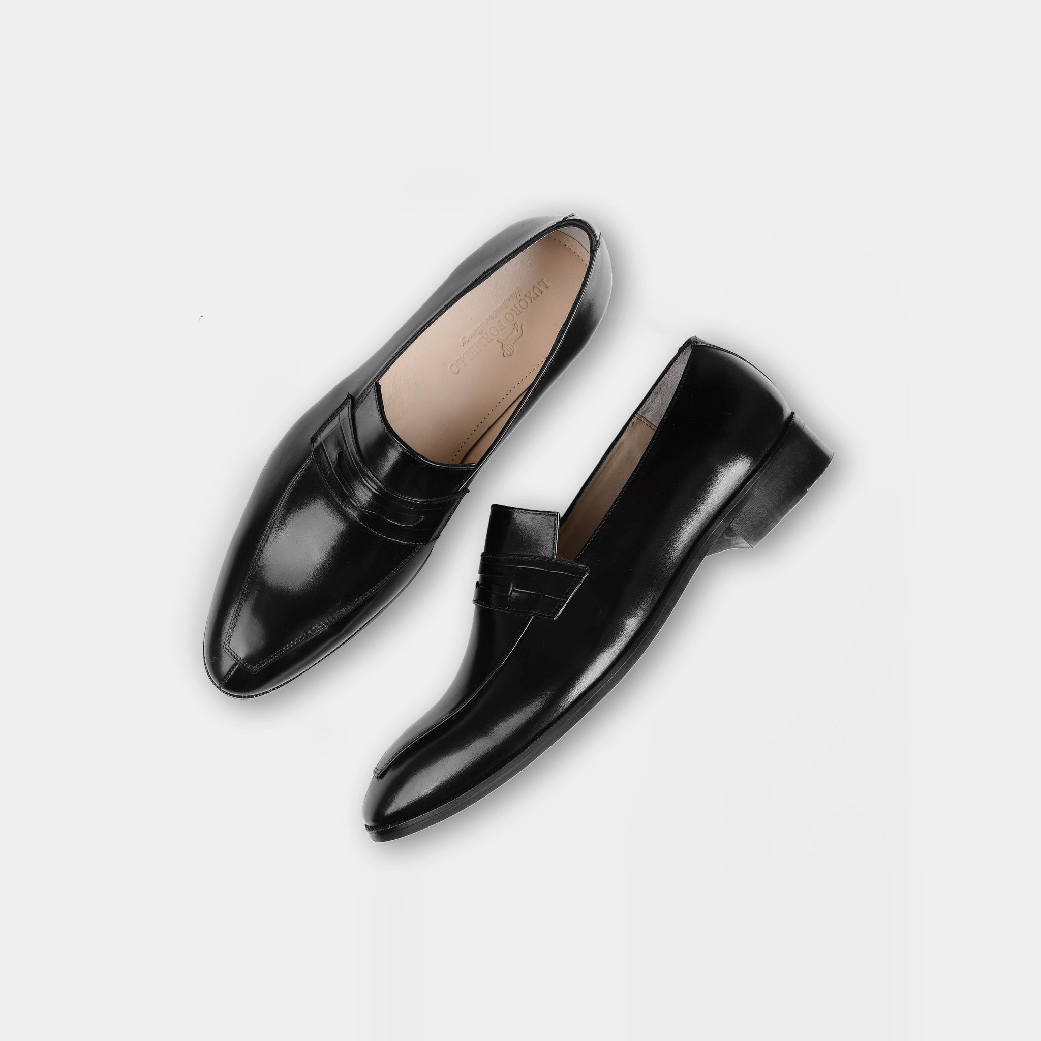 Pair of Alarico Black Leather Loafers on a white background.