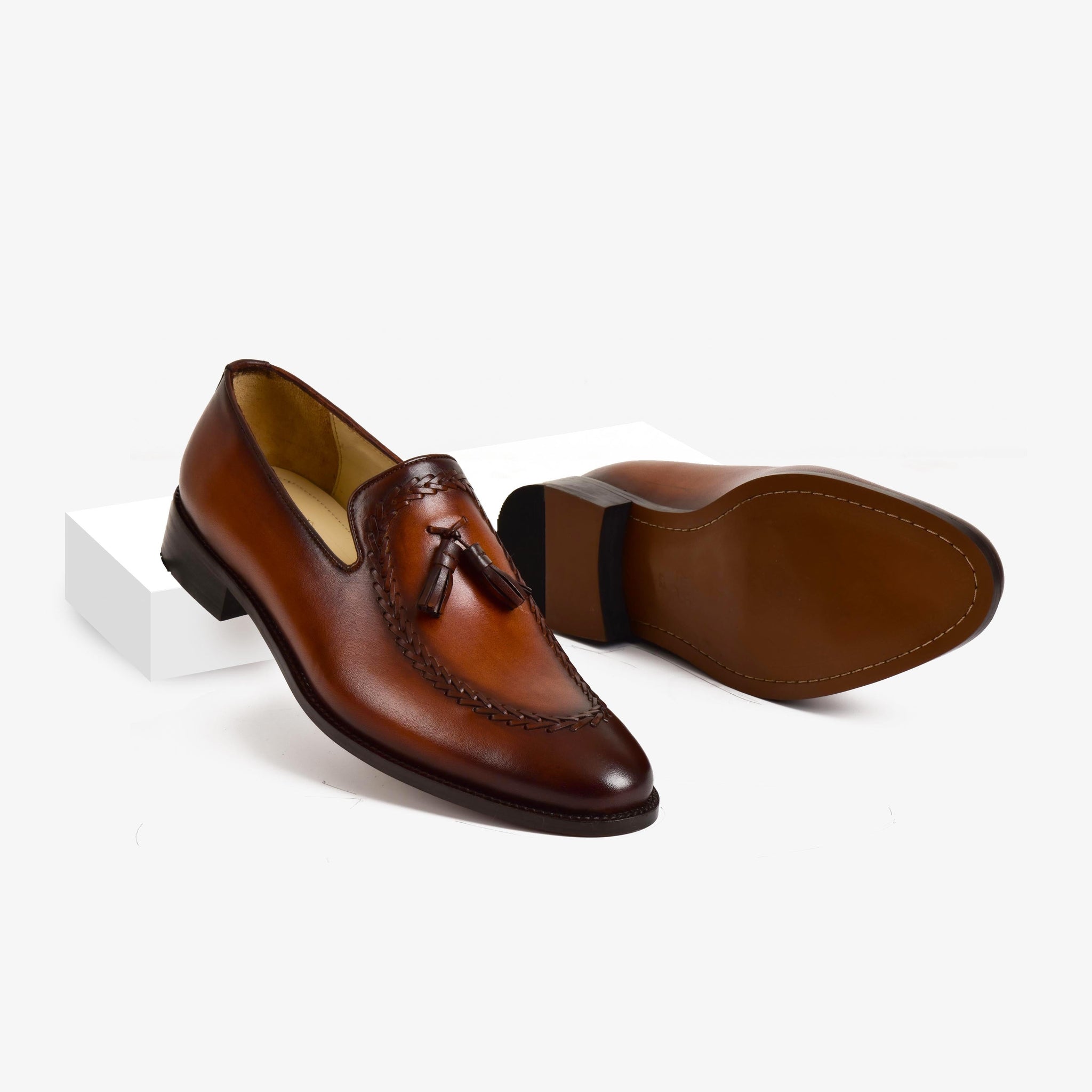 Pair of Peter Norwan Leather Loafers in brown, featuring a tasseled front with detailed stitching on the vamp.